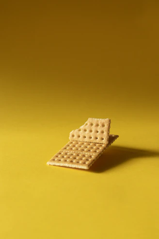 A broken cracker with a bite taken out