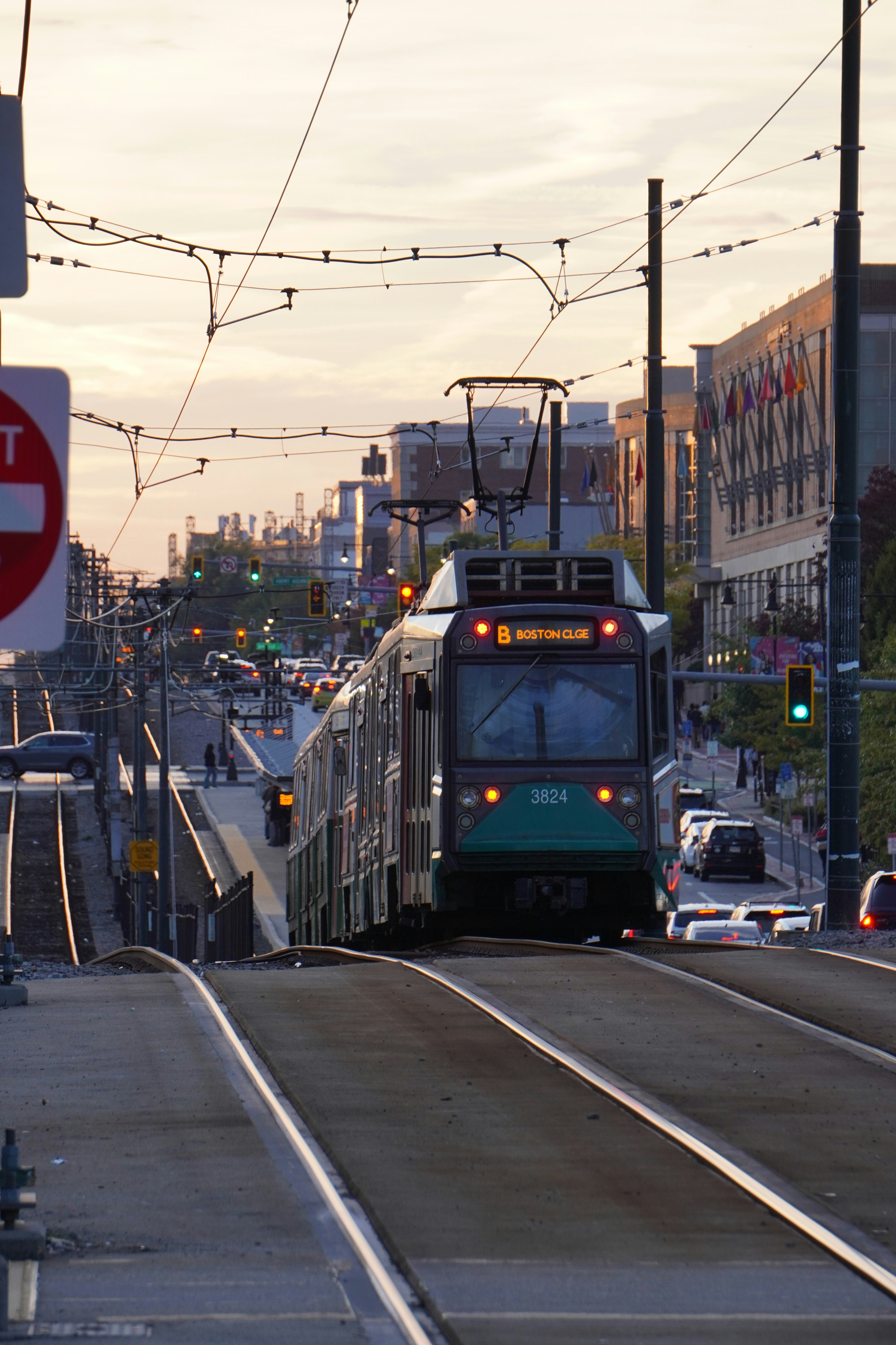 A modern tram travels through a city street.