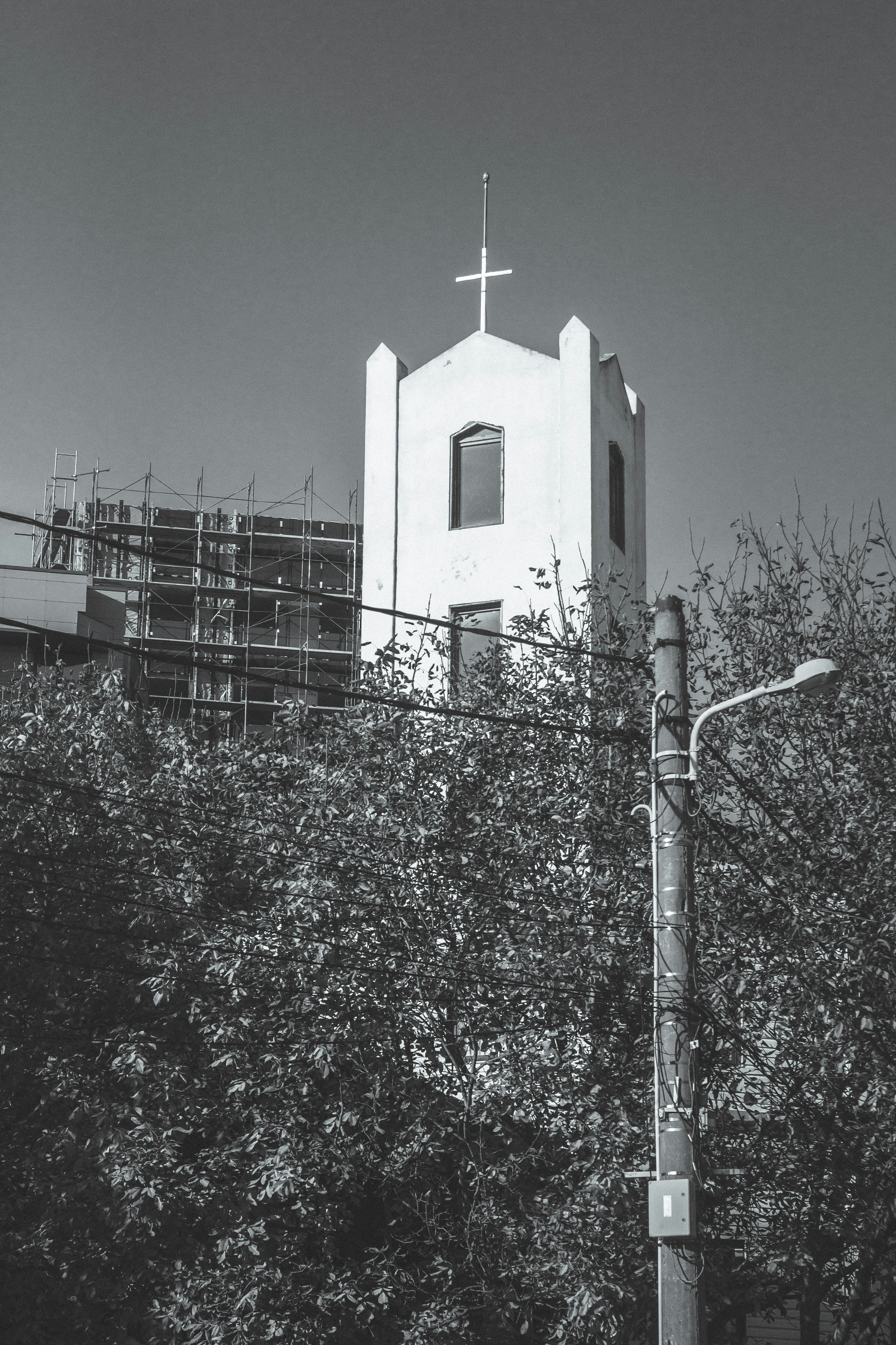 White church steeple with cross against sky