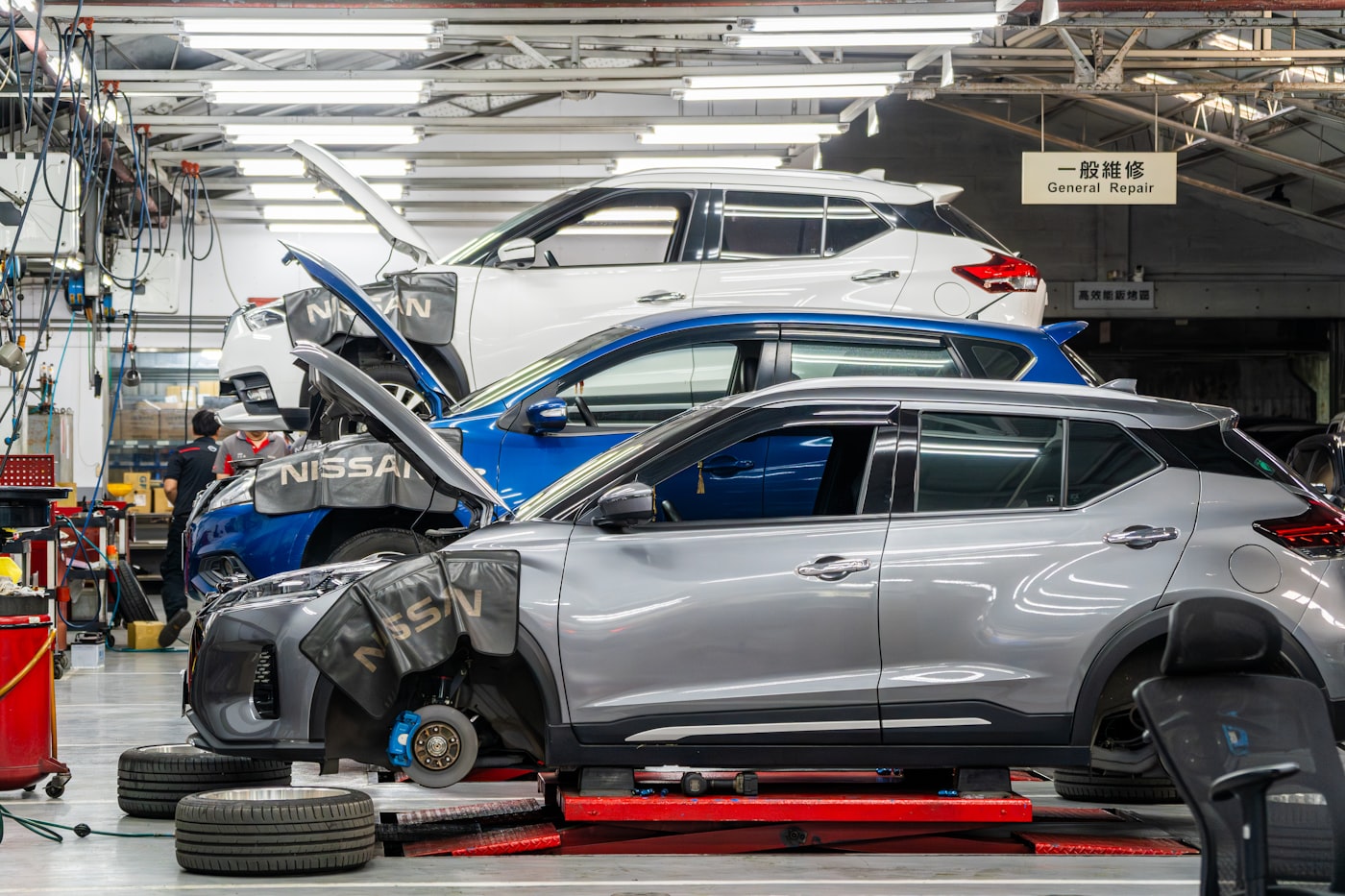 Cars raised in a service-bay workshop &mdash; where most replacement rental car in New Hampshire searches begin