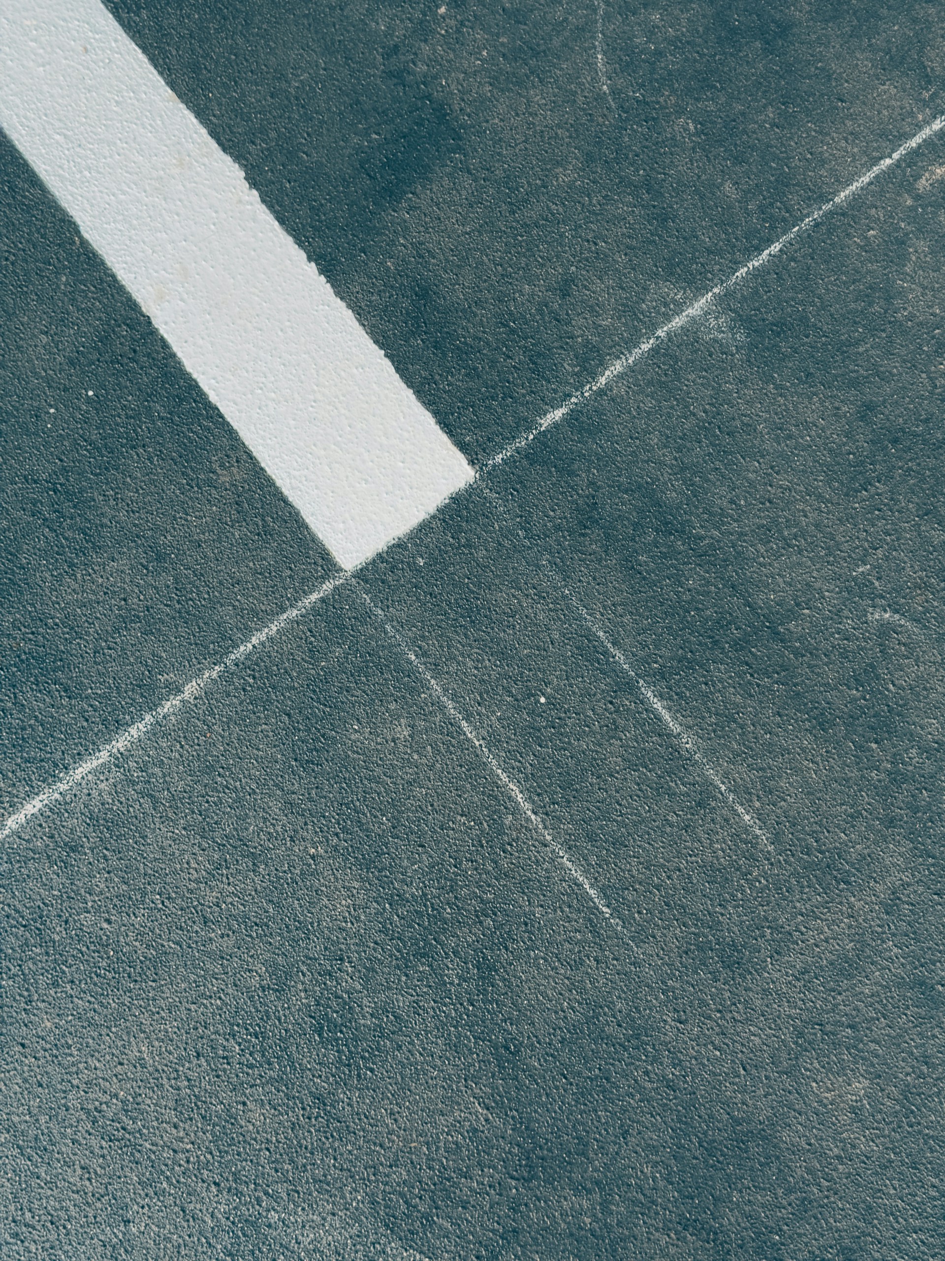 Diagonal white line on dark textured surface