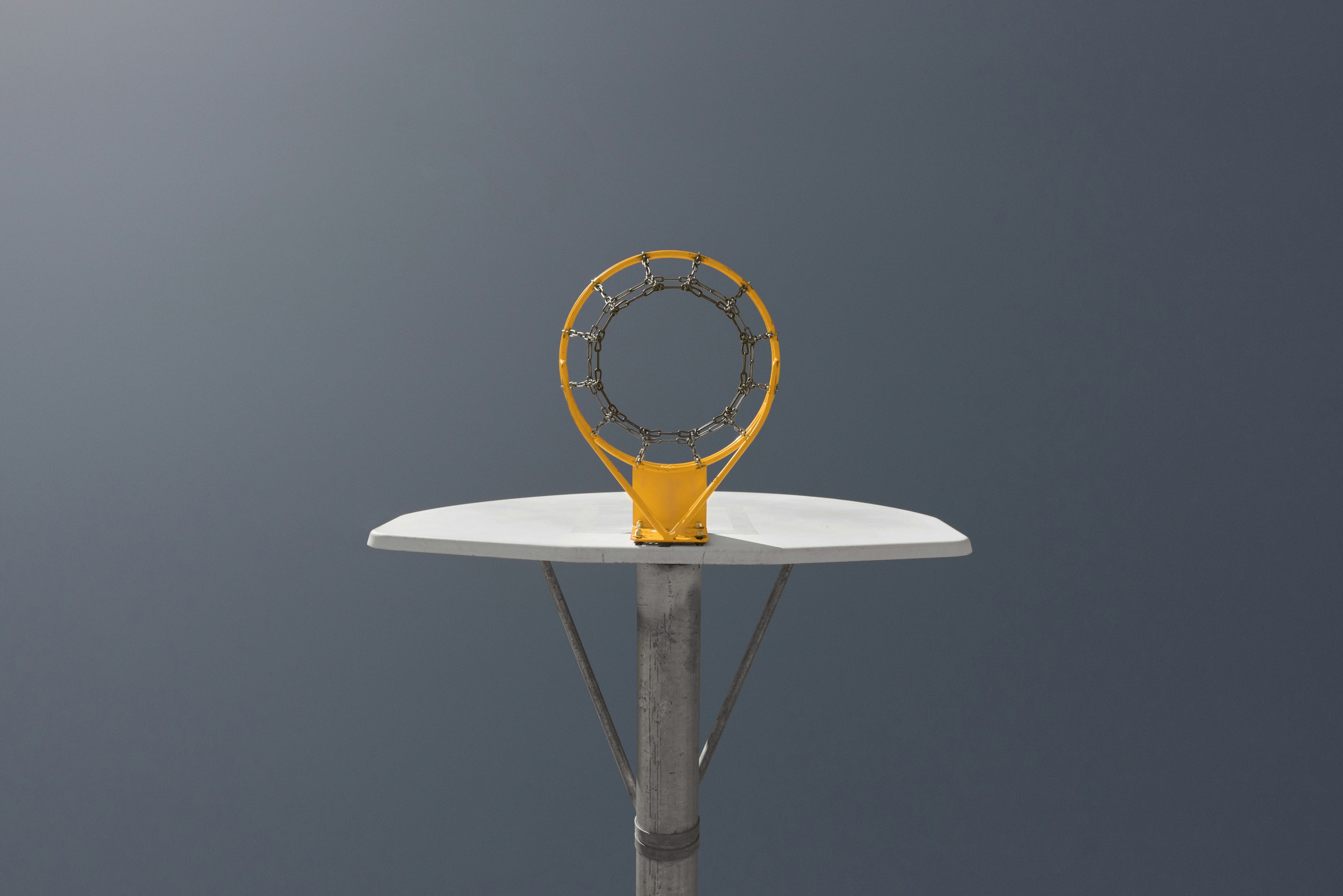 운동 의욕 안 날 때 동기 부여 방식 - A basketball hoop and backboard against a gray background