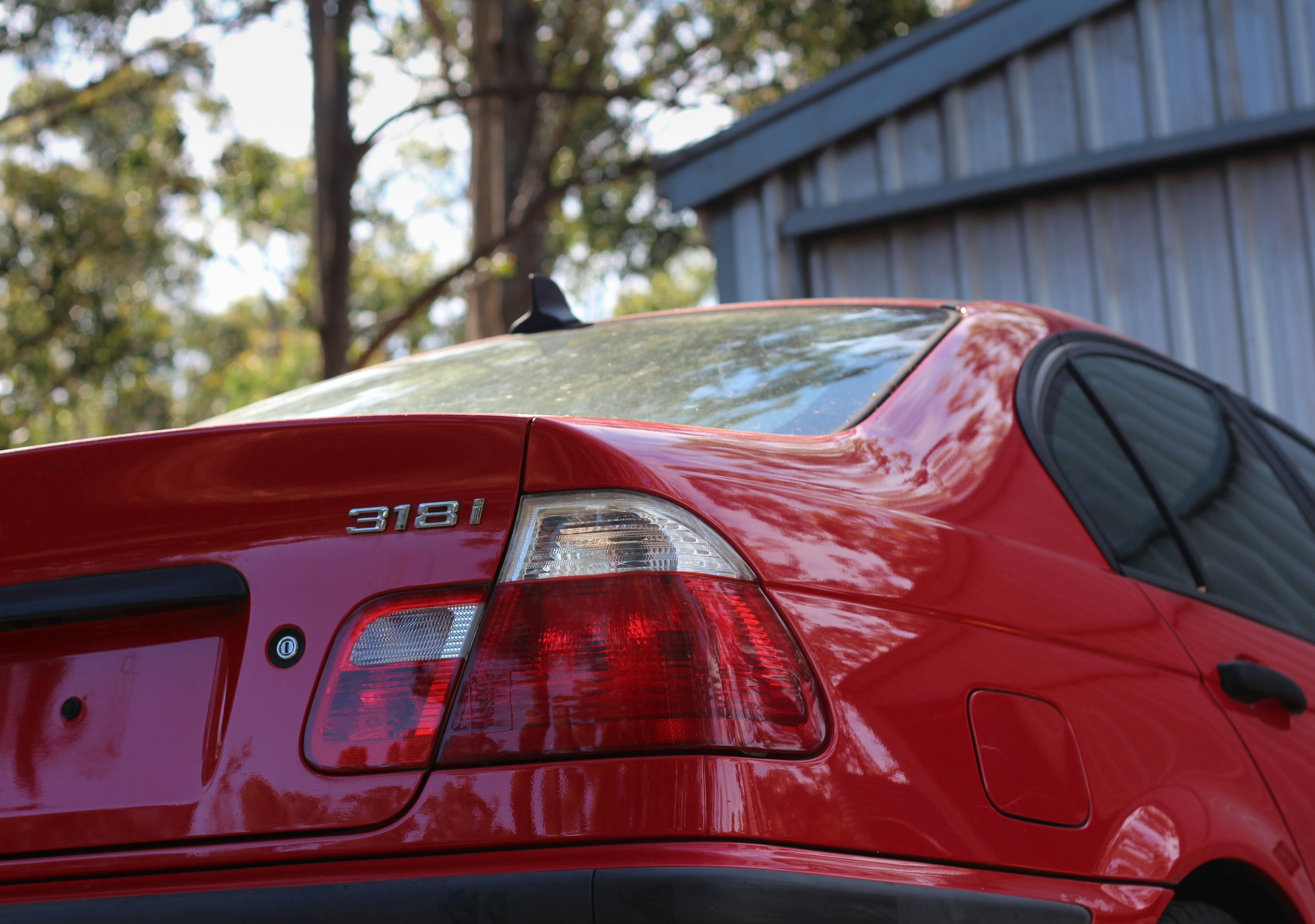 Red BMW 318i sedan parked outdoors