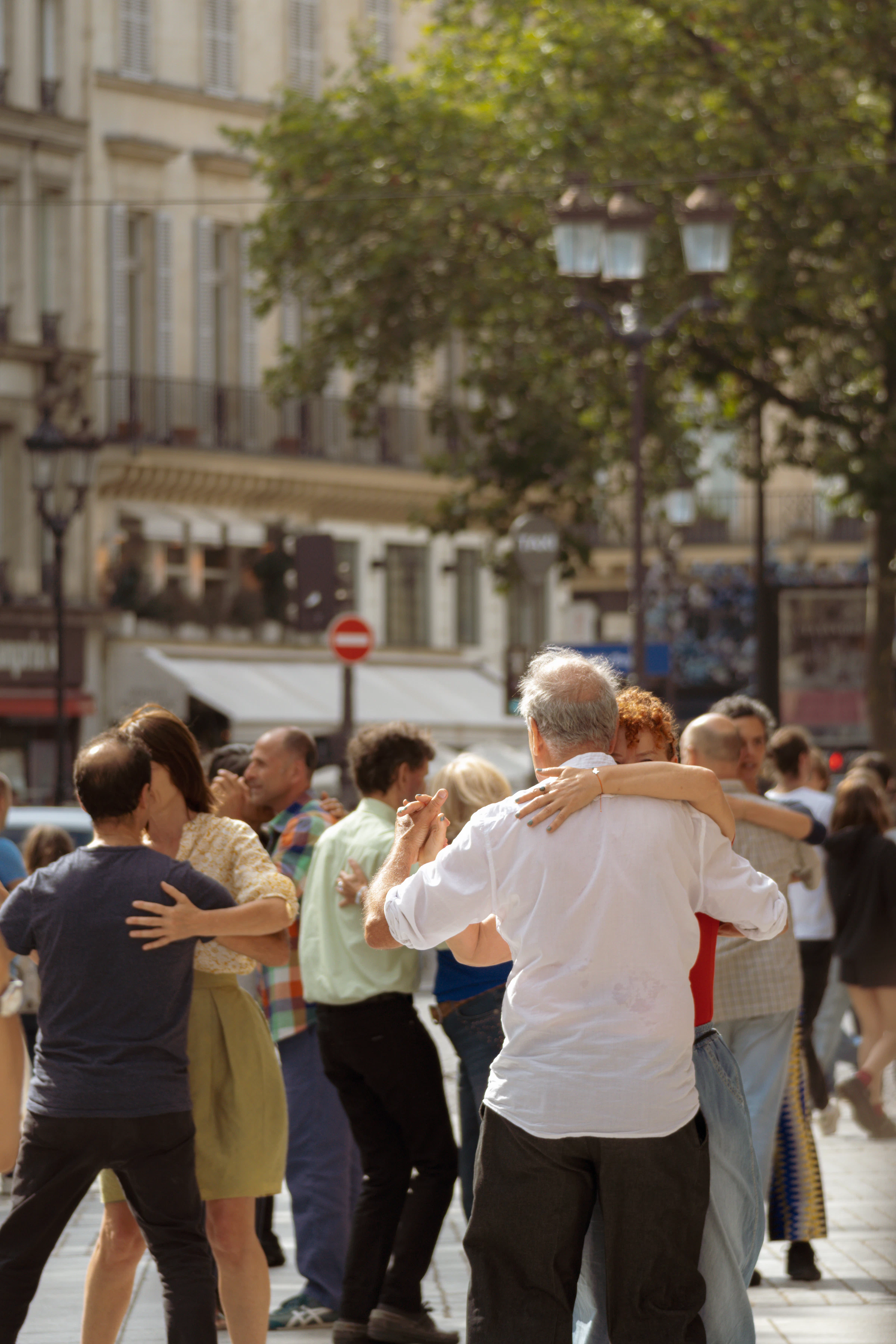 People dancing together in a city square