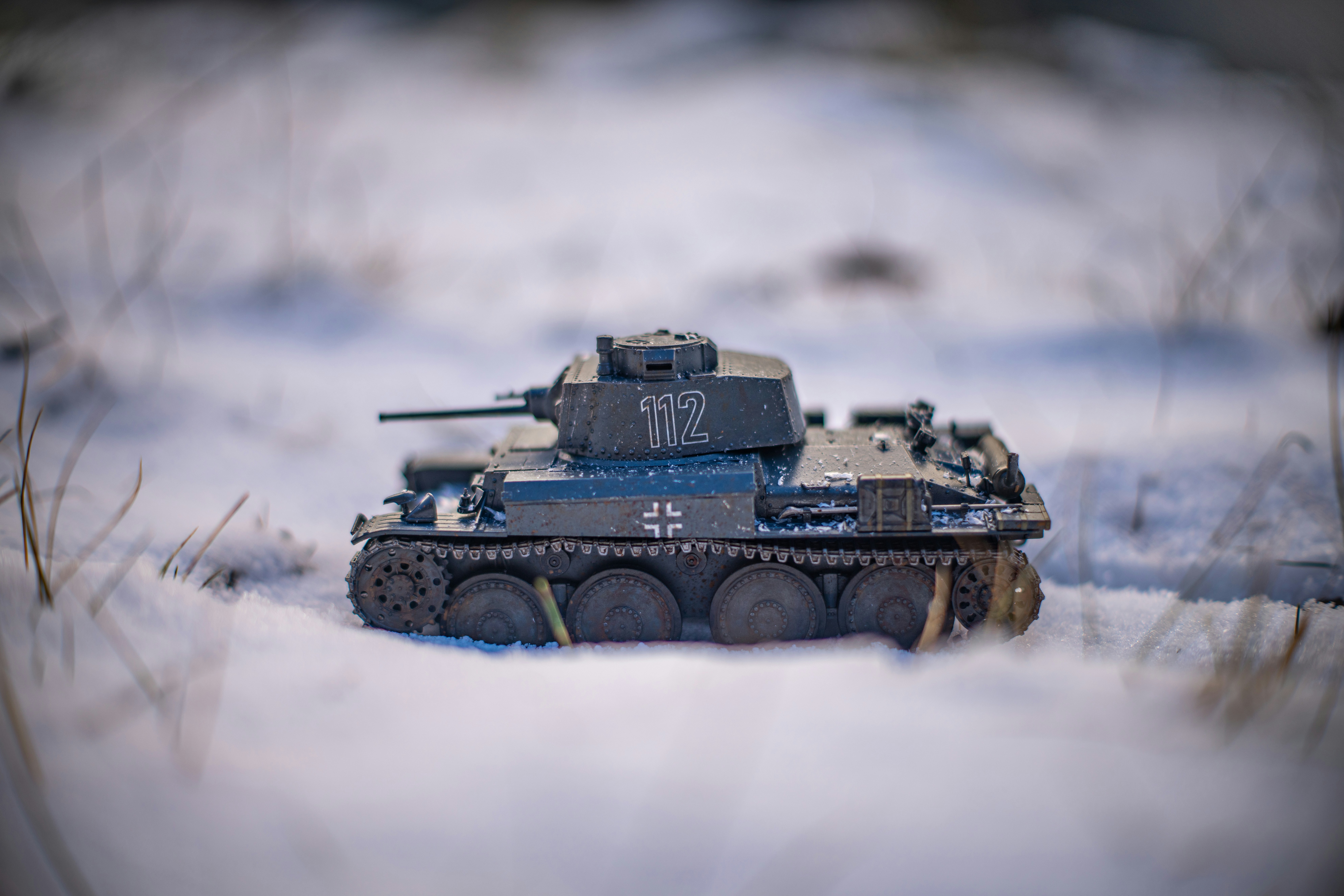 A miniature tank in a snowy landscape.