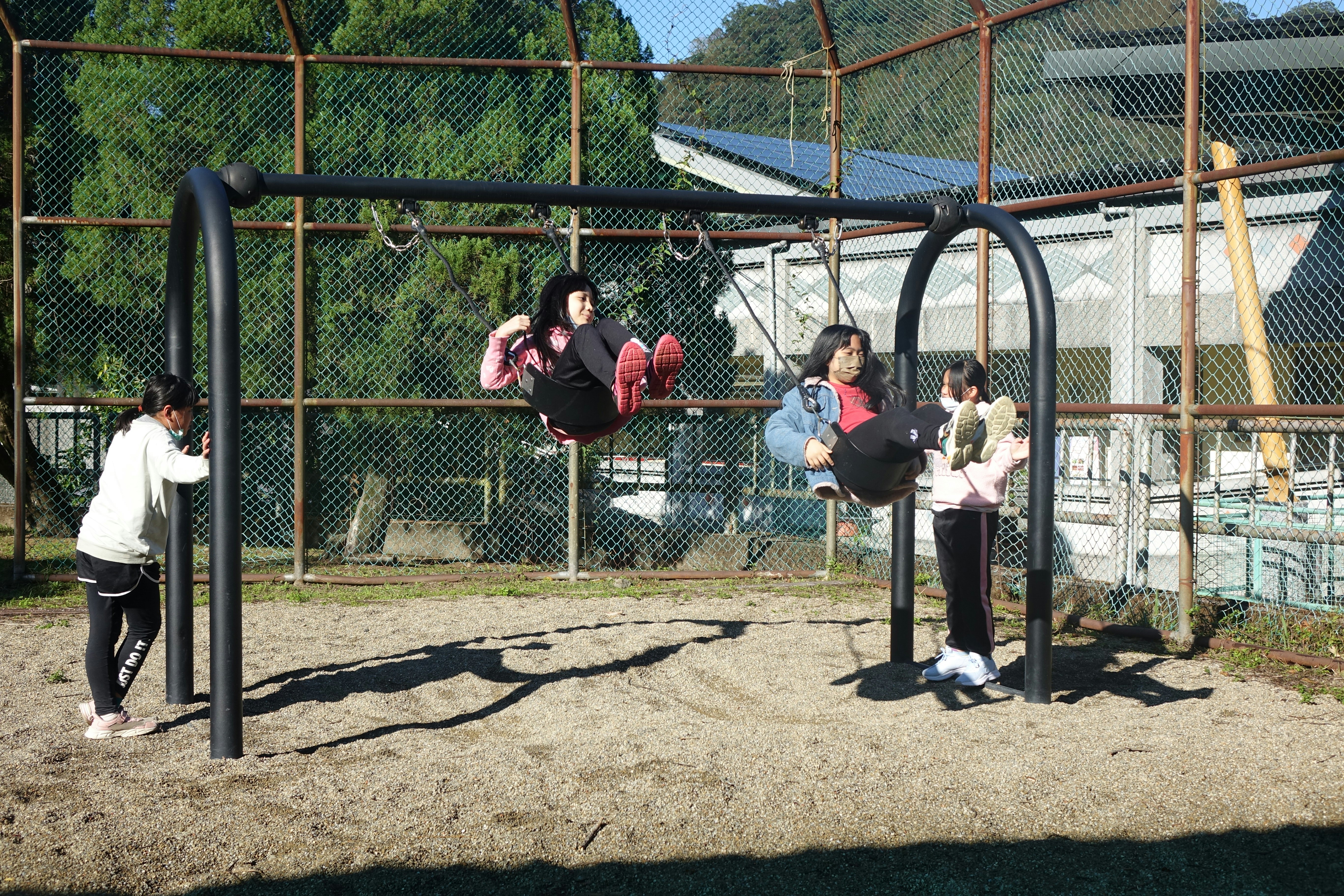 Children playing on a swing set outdoors