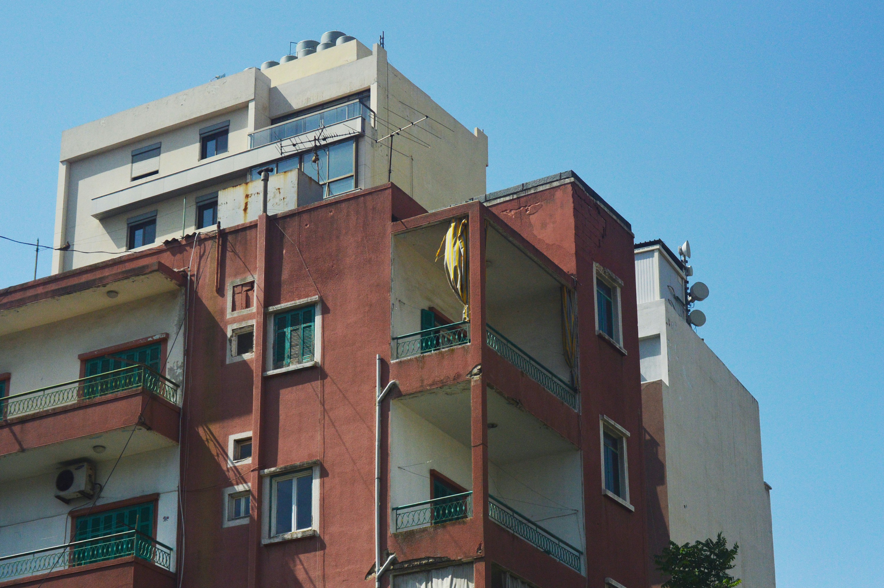 Modern apartment buildings against a clear blue sky.