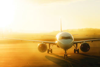 Airplane on tarmac at sunrise