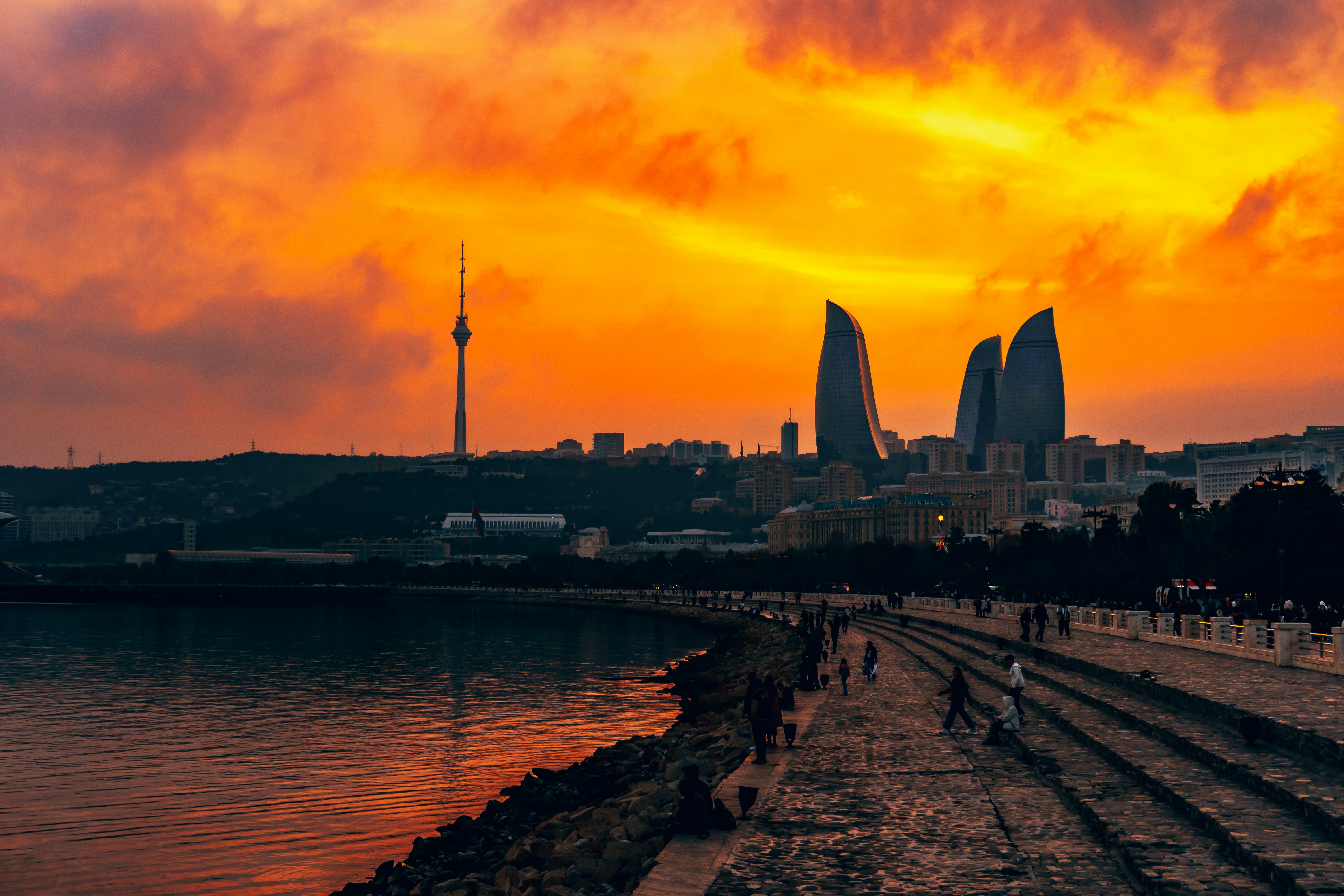 Cityscape with flame-shaped buildings at sunset