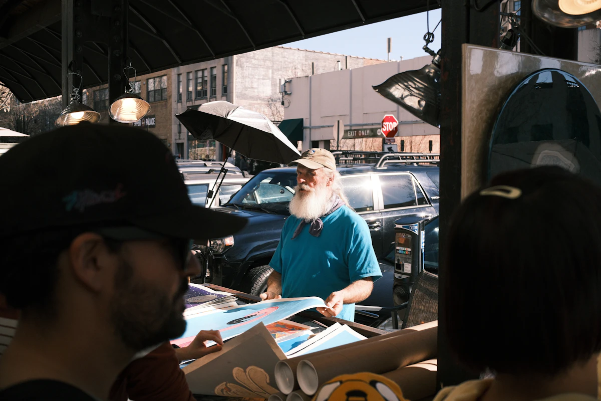 Independent artist presenting paintings at an outdoor market