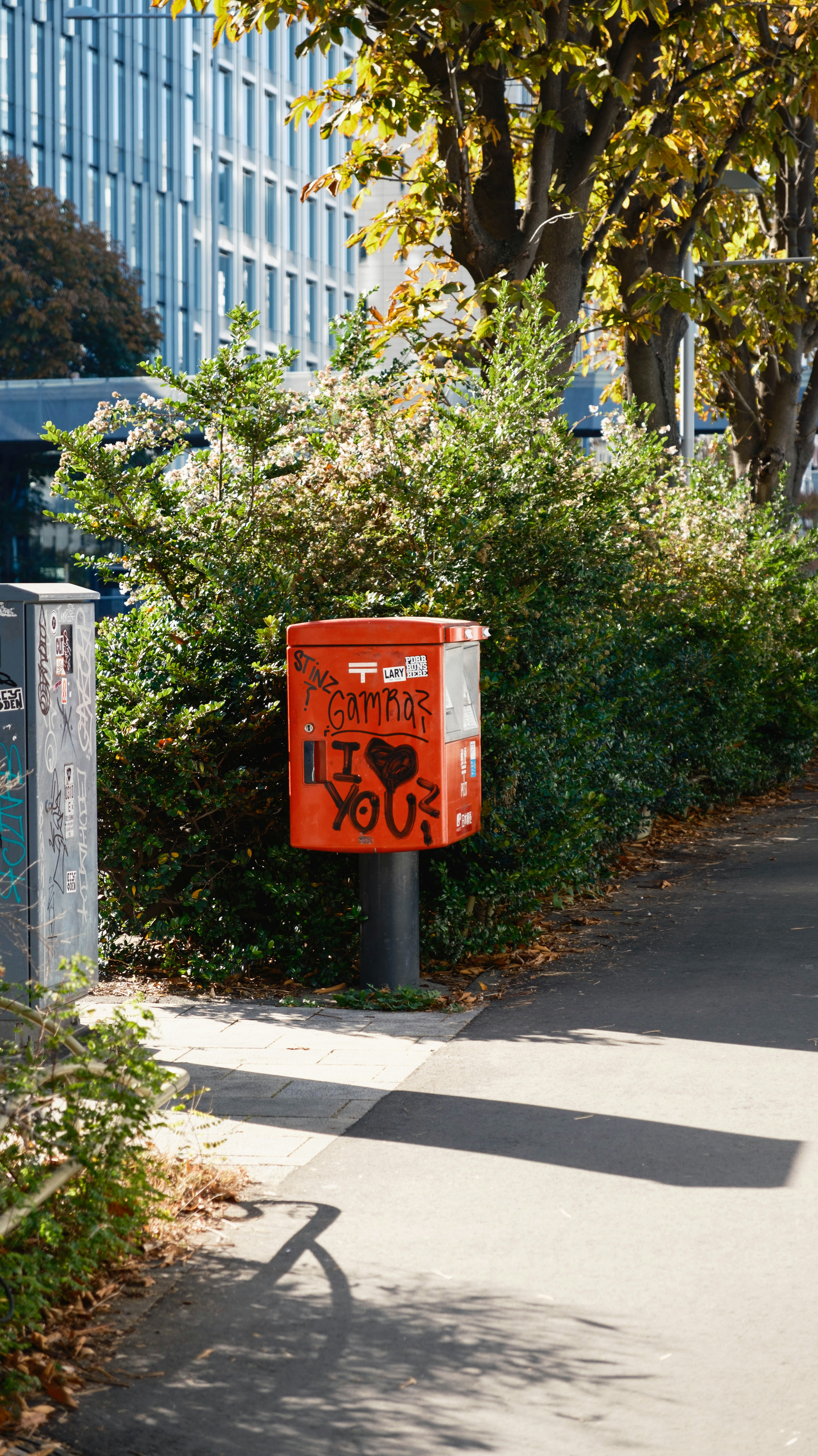 Red mailbox with graffiti saying "i love you".