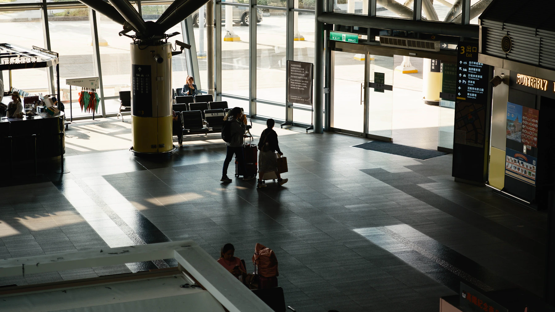 Traveler moving through a modern airport with rolling luggage