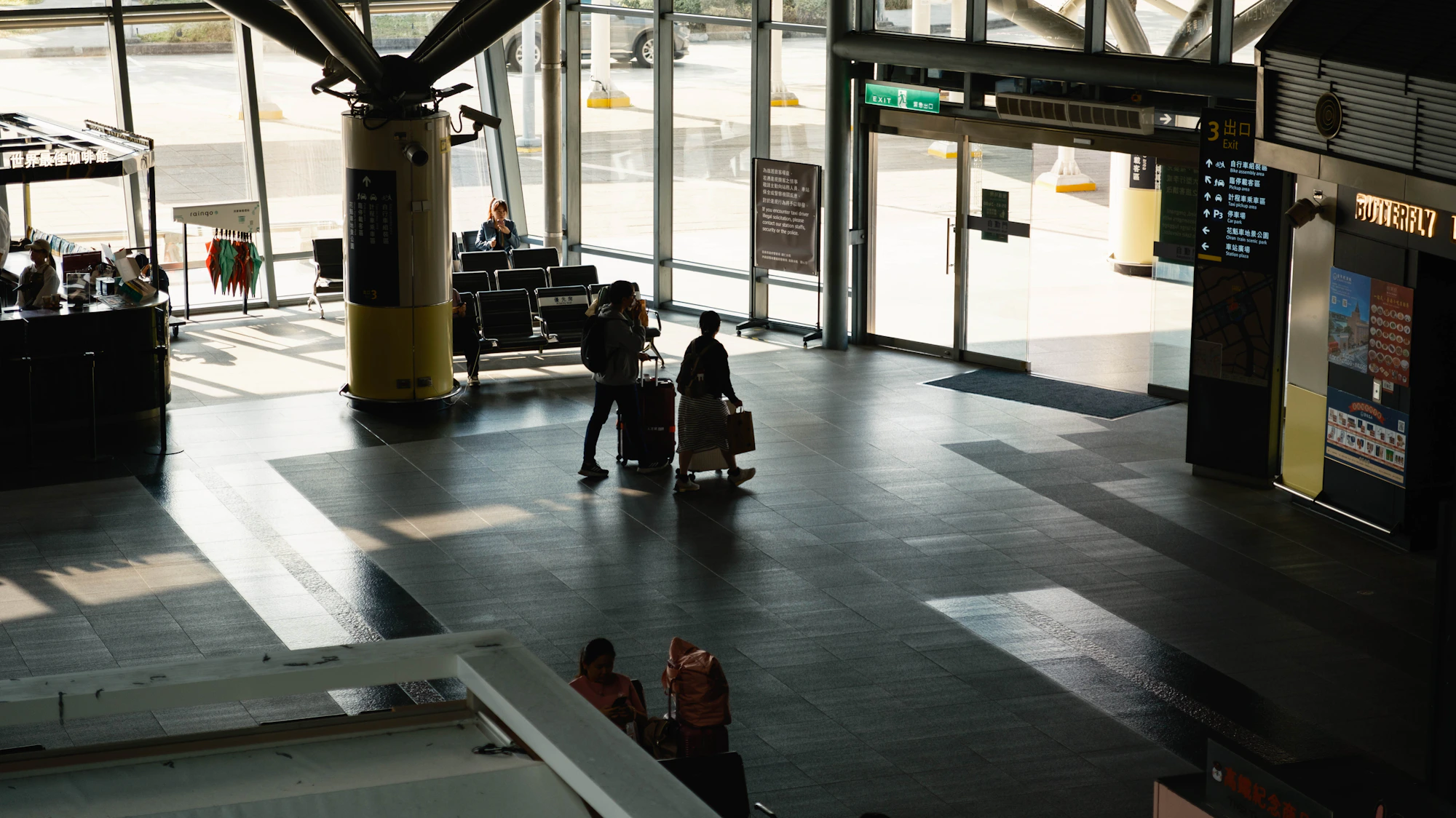 Traveler moving through a modern airport with rolling luggage