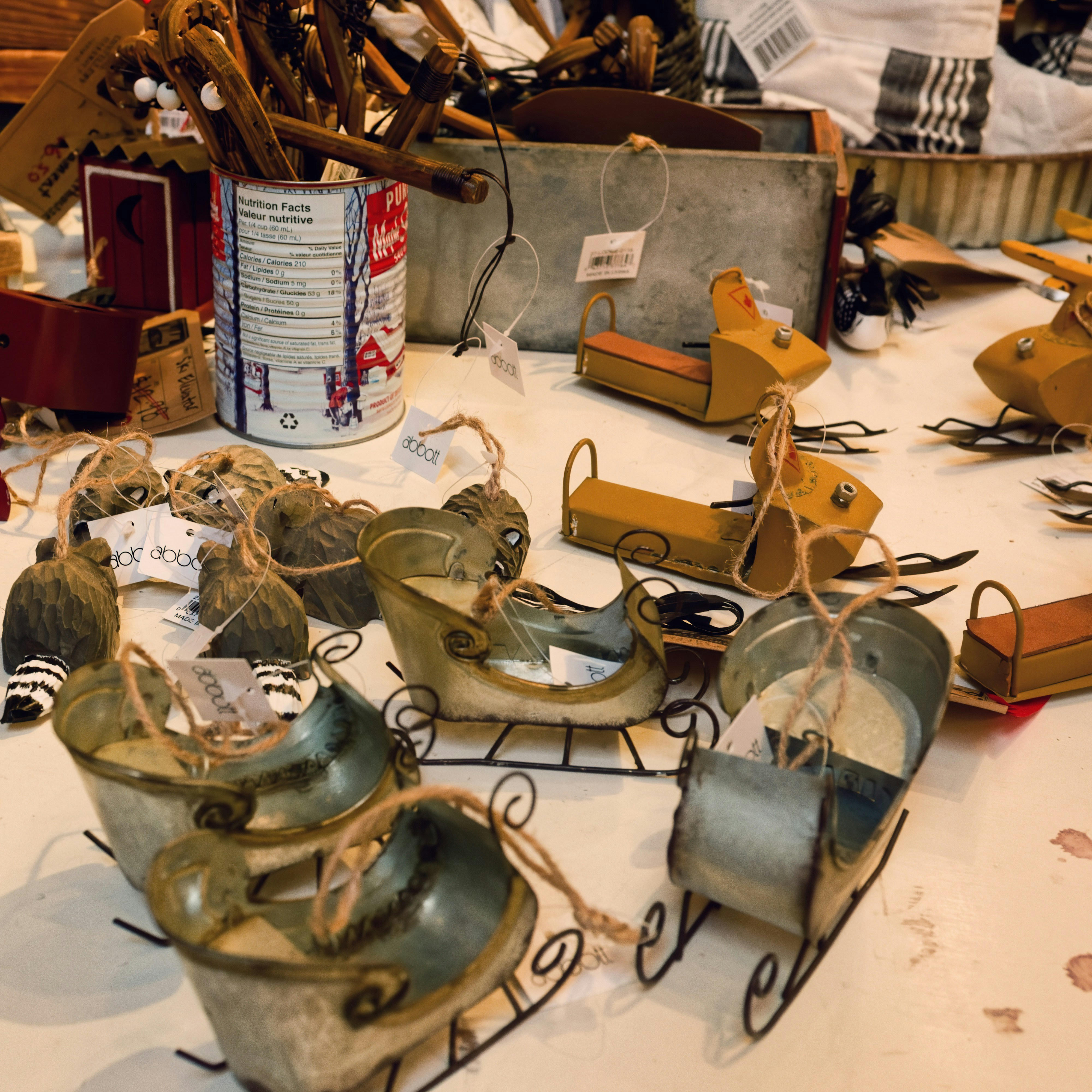 Small decorative sleds and ornaments on a table.