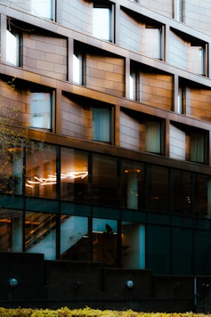 Modern building facade with geometric windows and reflections