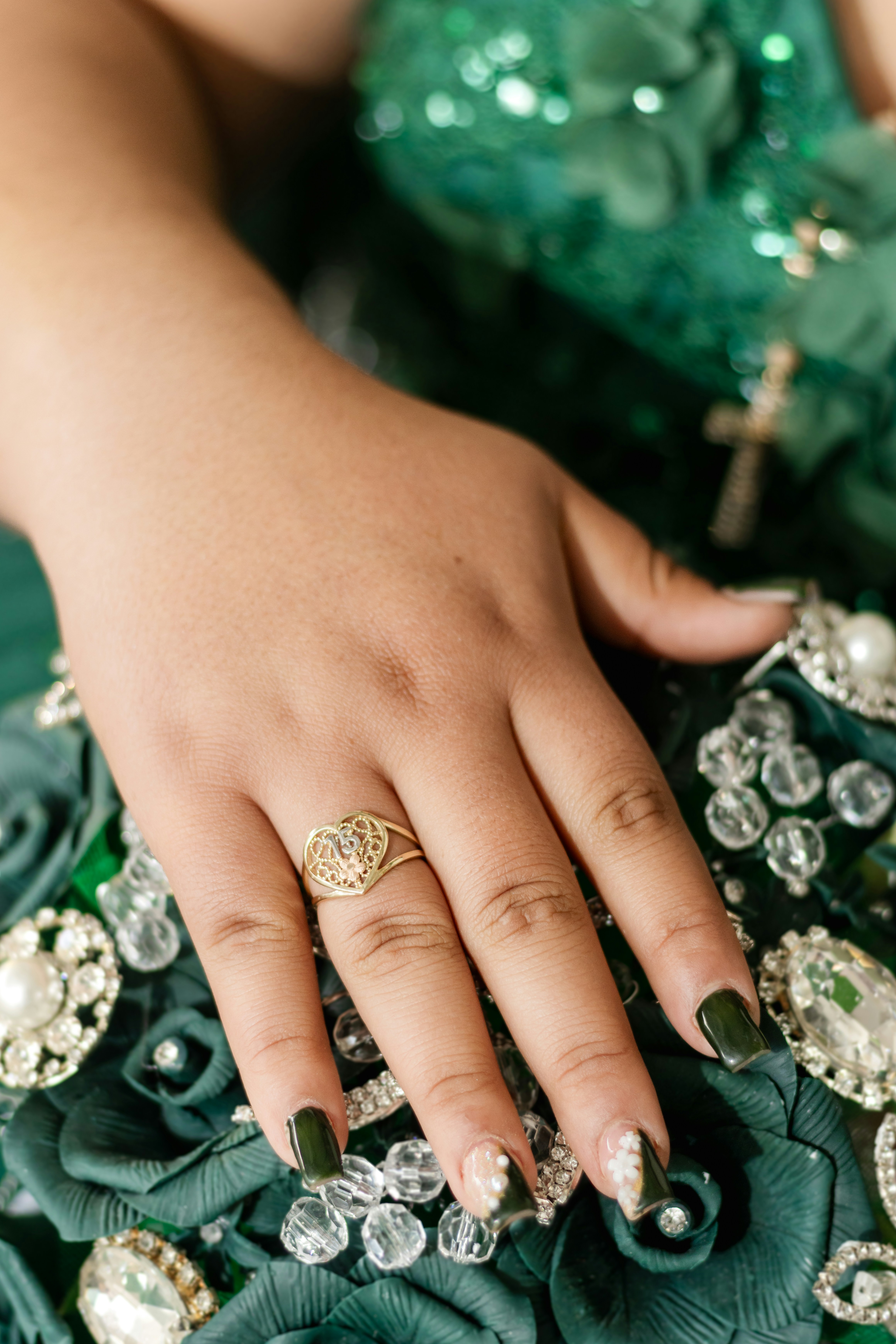 Woman's hand with heart ring on bouquet