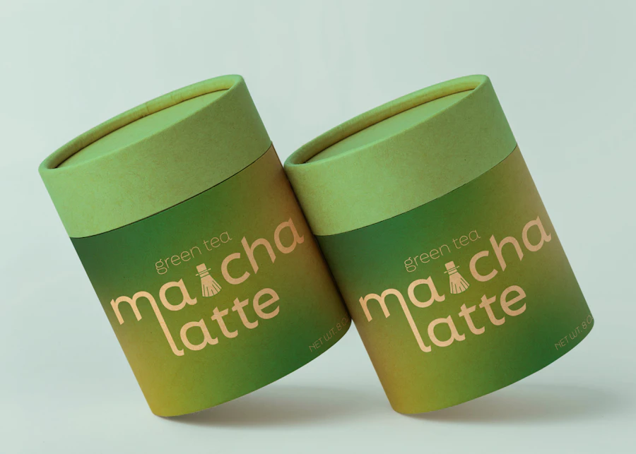 Two green matcha latte canisters on a pale green background