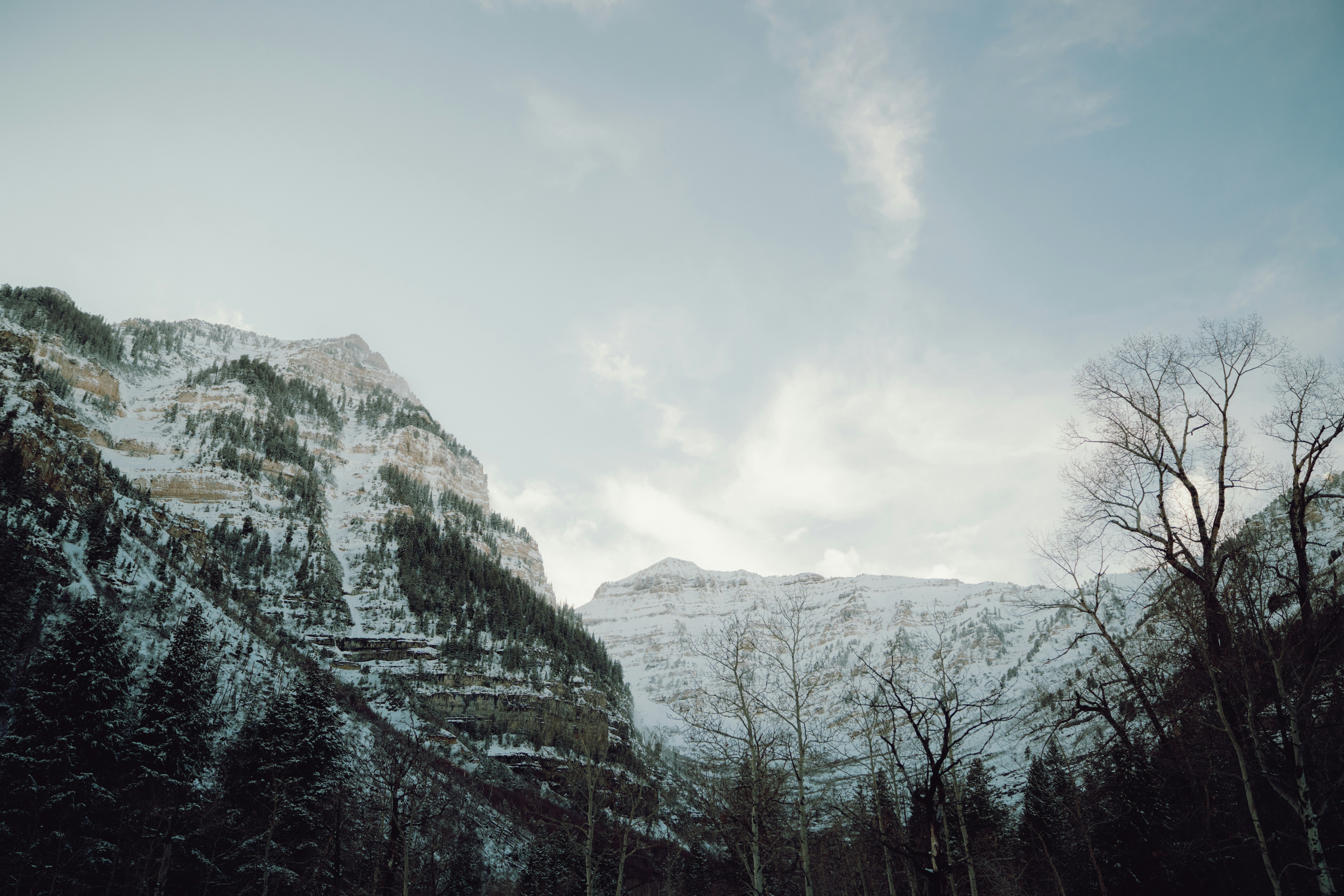 Snow-covered mountains under a cloudy sky