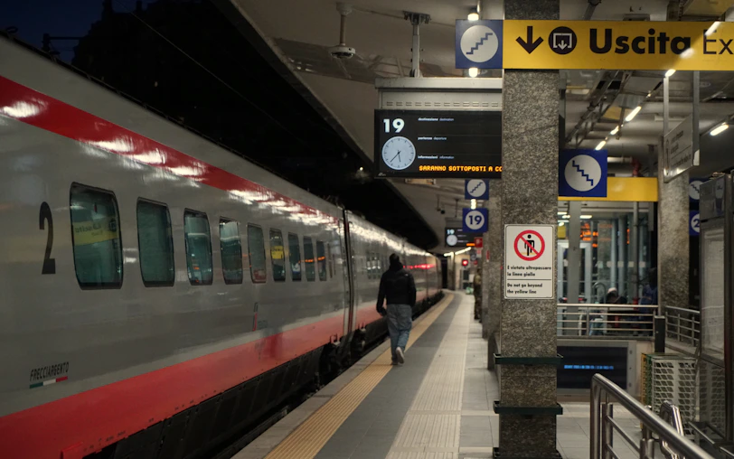 Train at a station platform with exit sign
