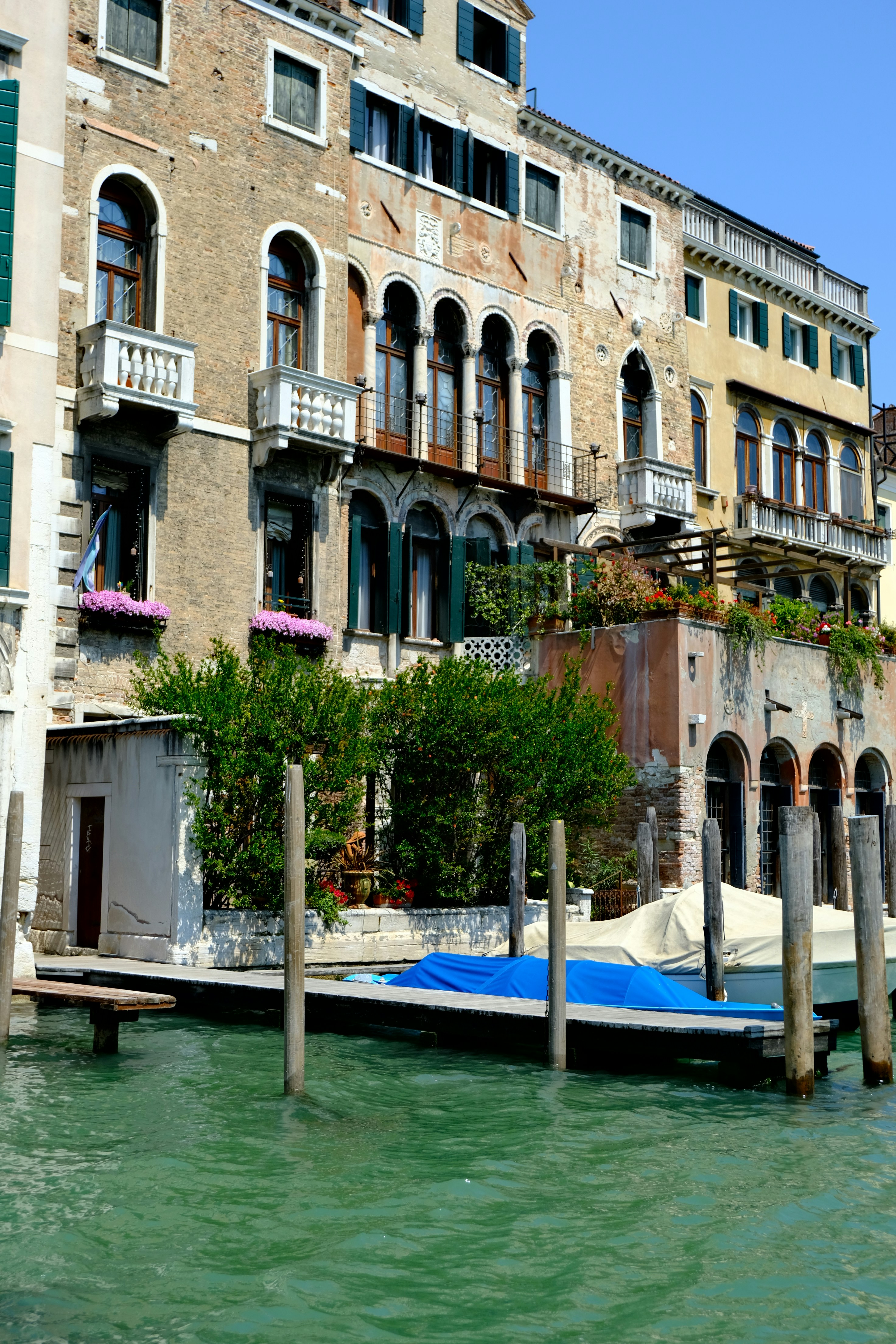 Venetian buildings along a canal with boats docked.