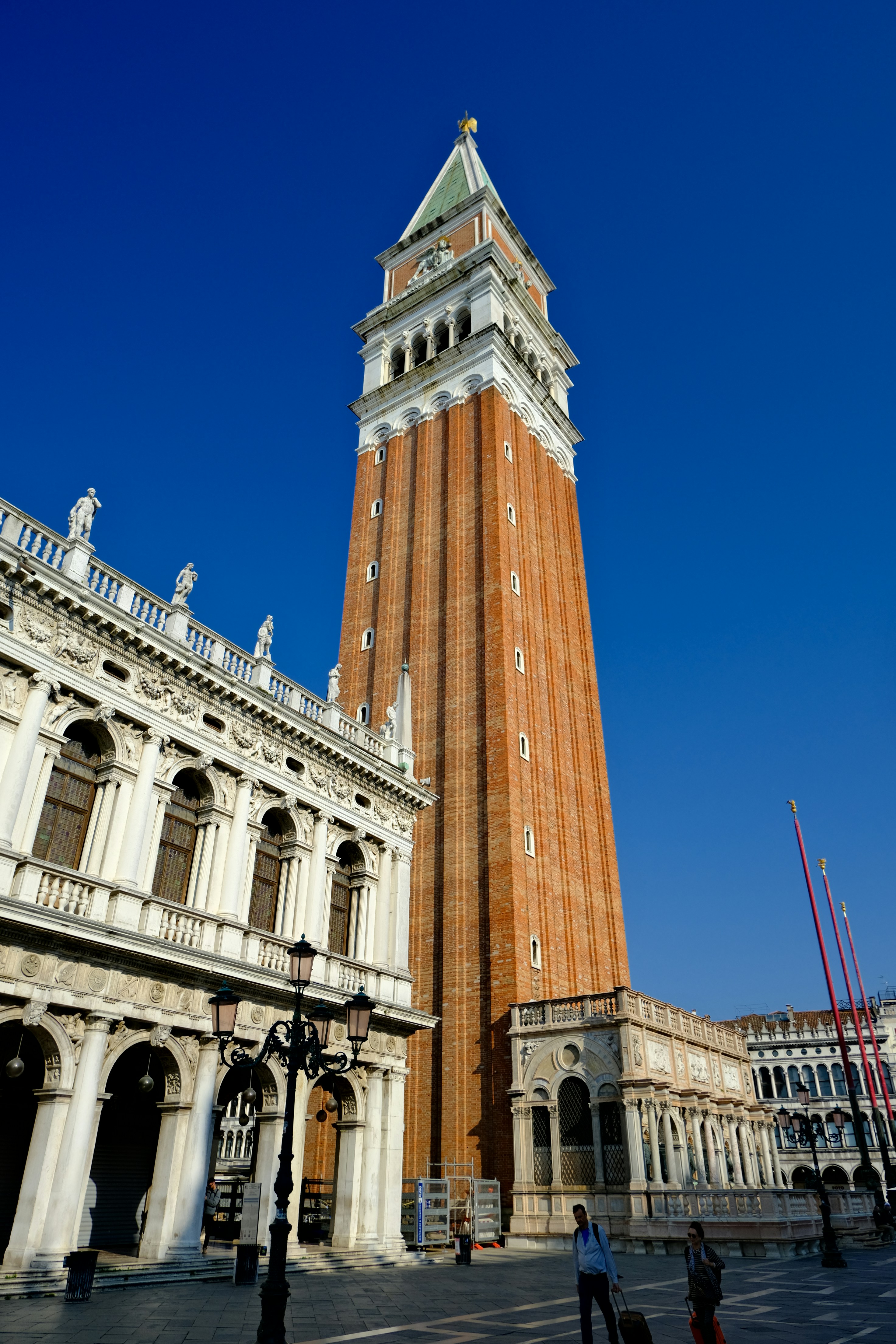 Tall brick bell tower with ornate building facade