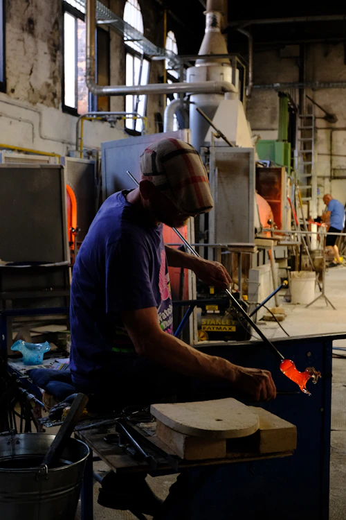 A master glassblower in Murano shaping molten glass into art with centuries-old technique