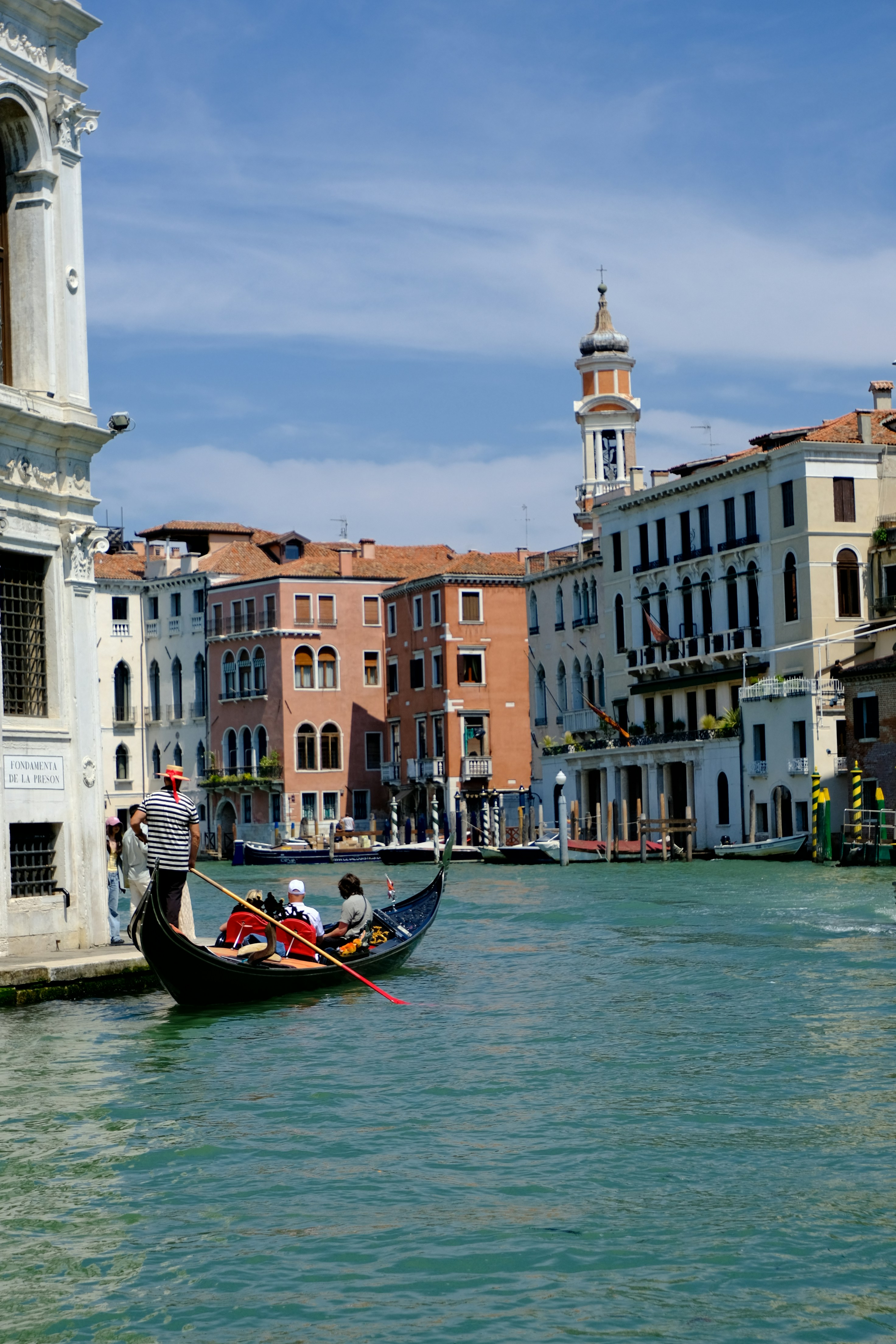 Gondola on a canal in venice with buildings.