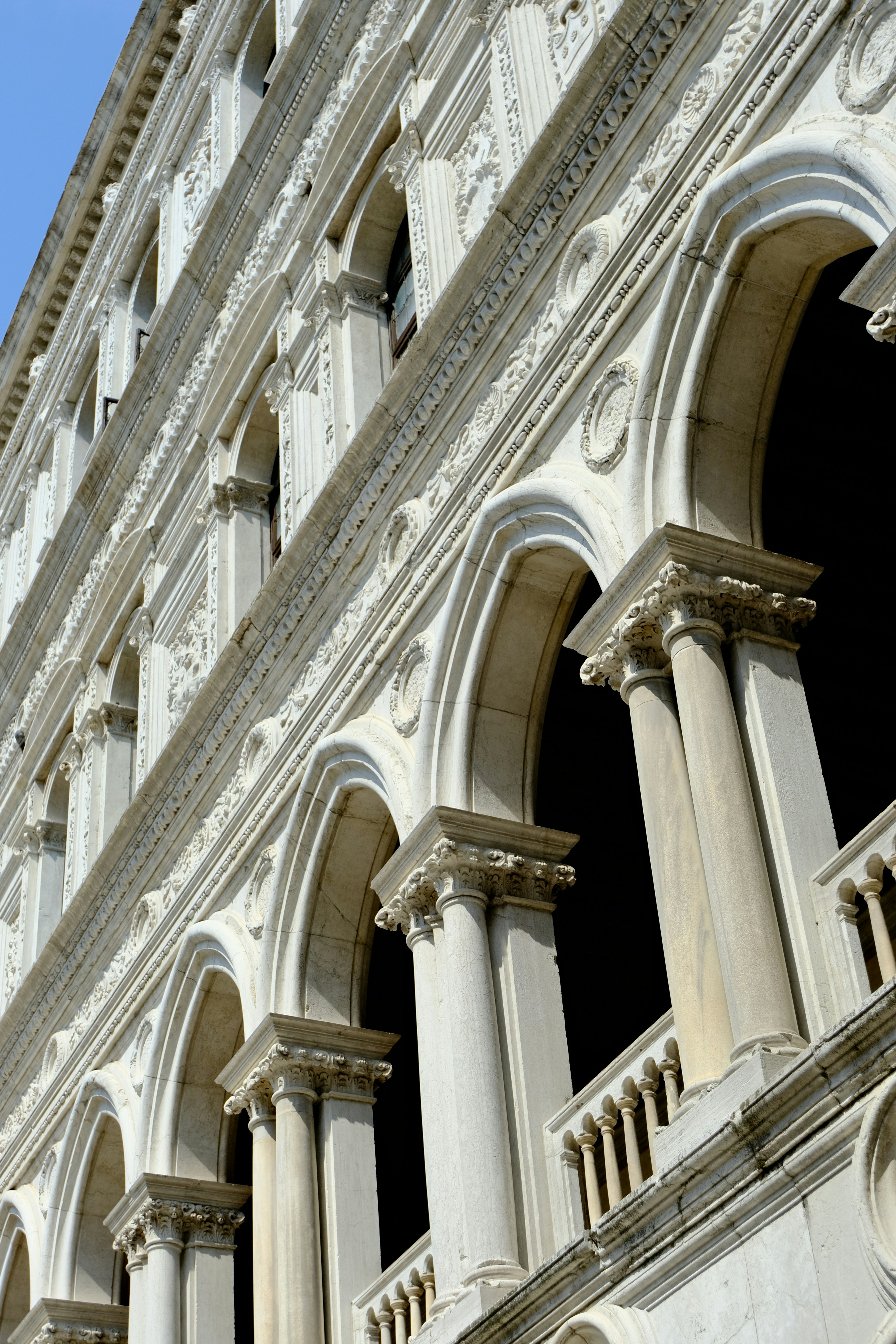 Ornate white building with arched windows and columns