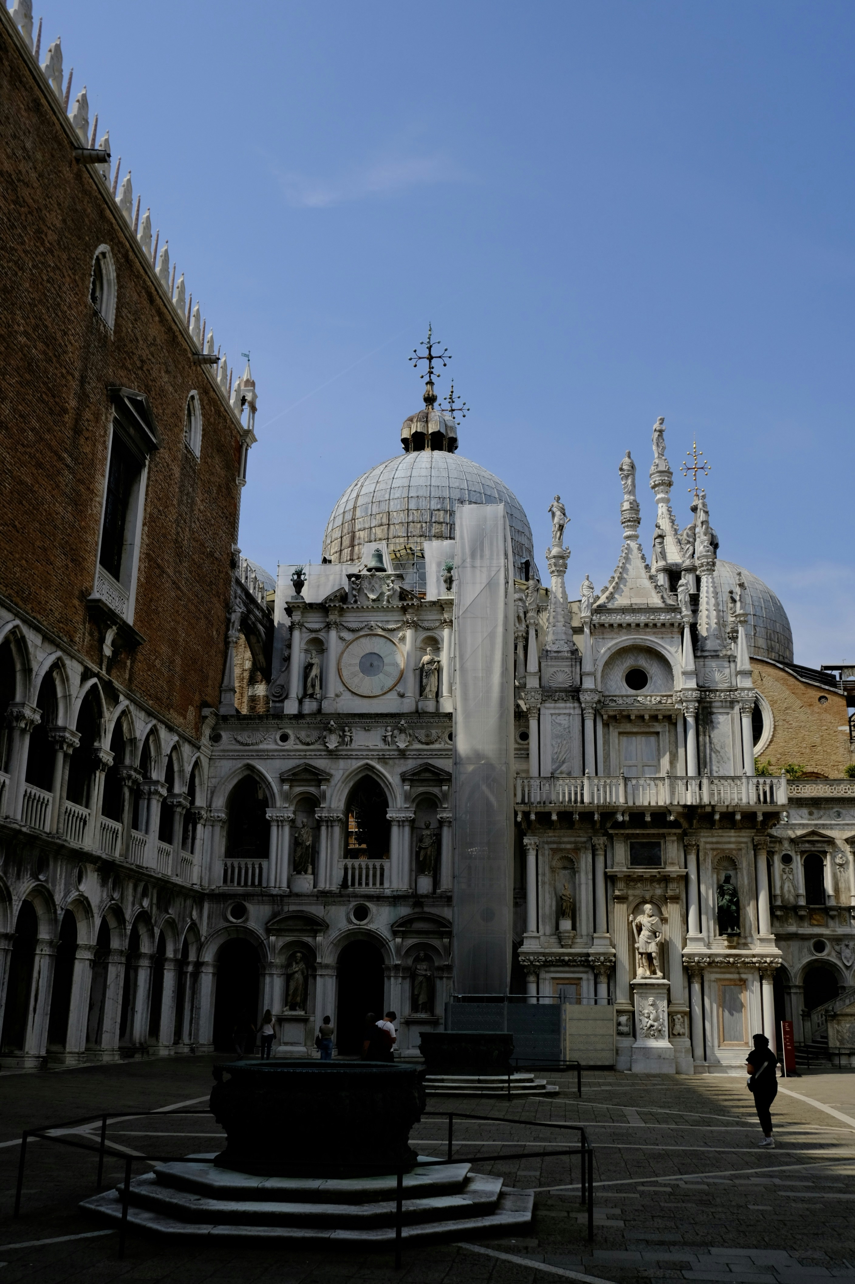 Ornate building with domes and arches under blue sky