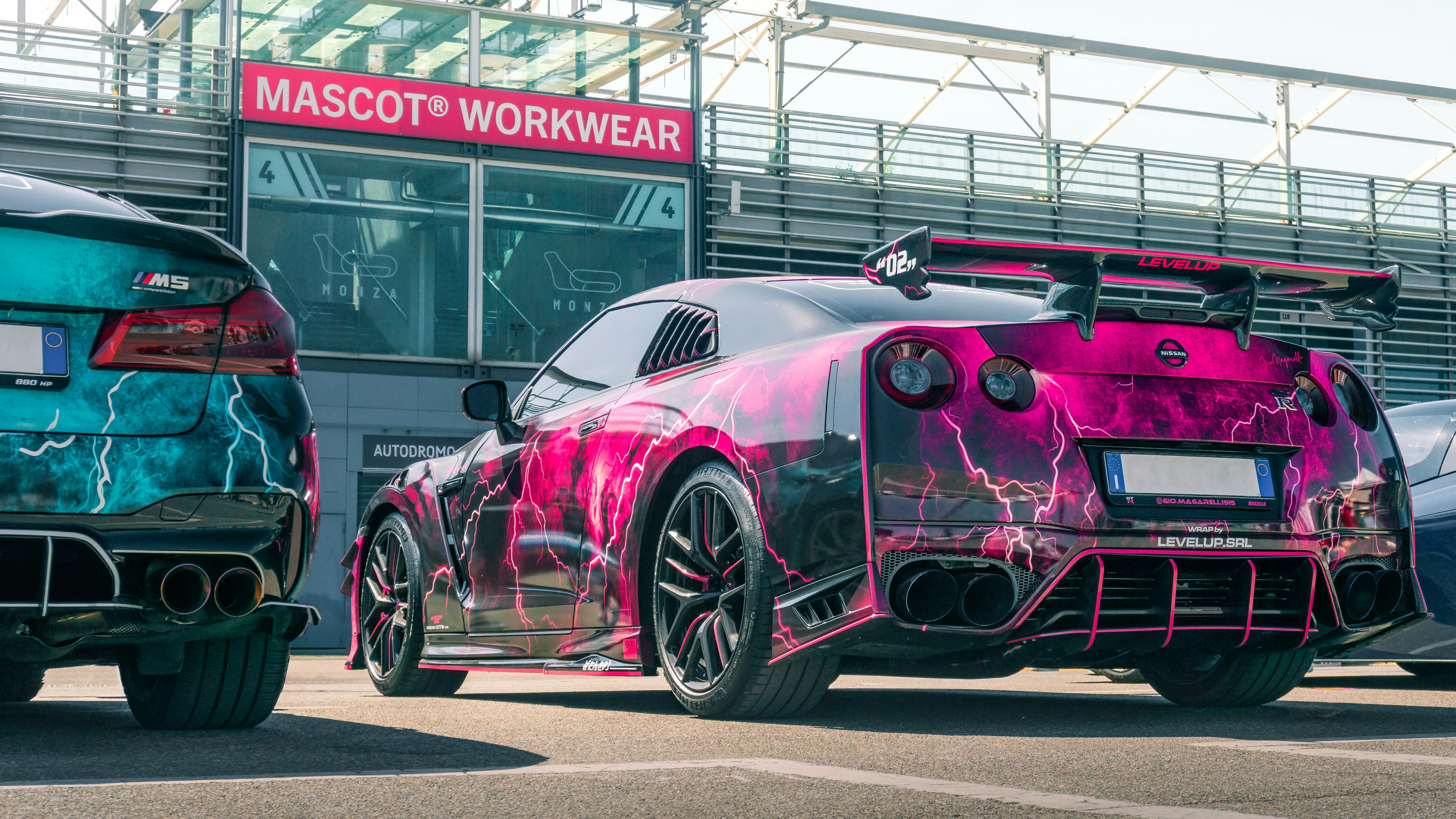 Deux voitures de sport aux motifs d’éclairs sont garées.