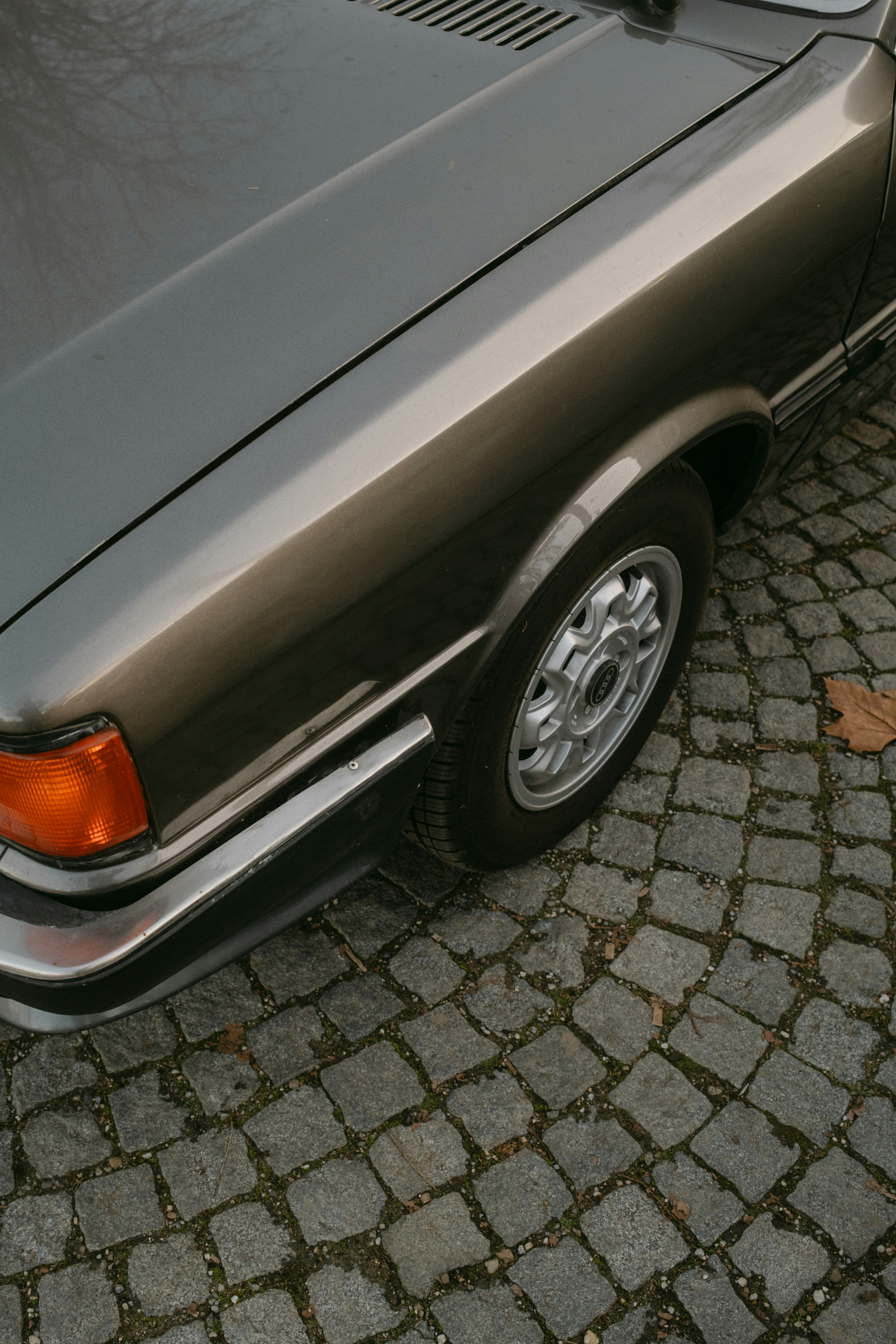 Close-up of a vintage car's fender and wheel.