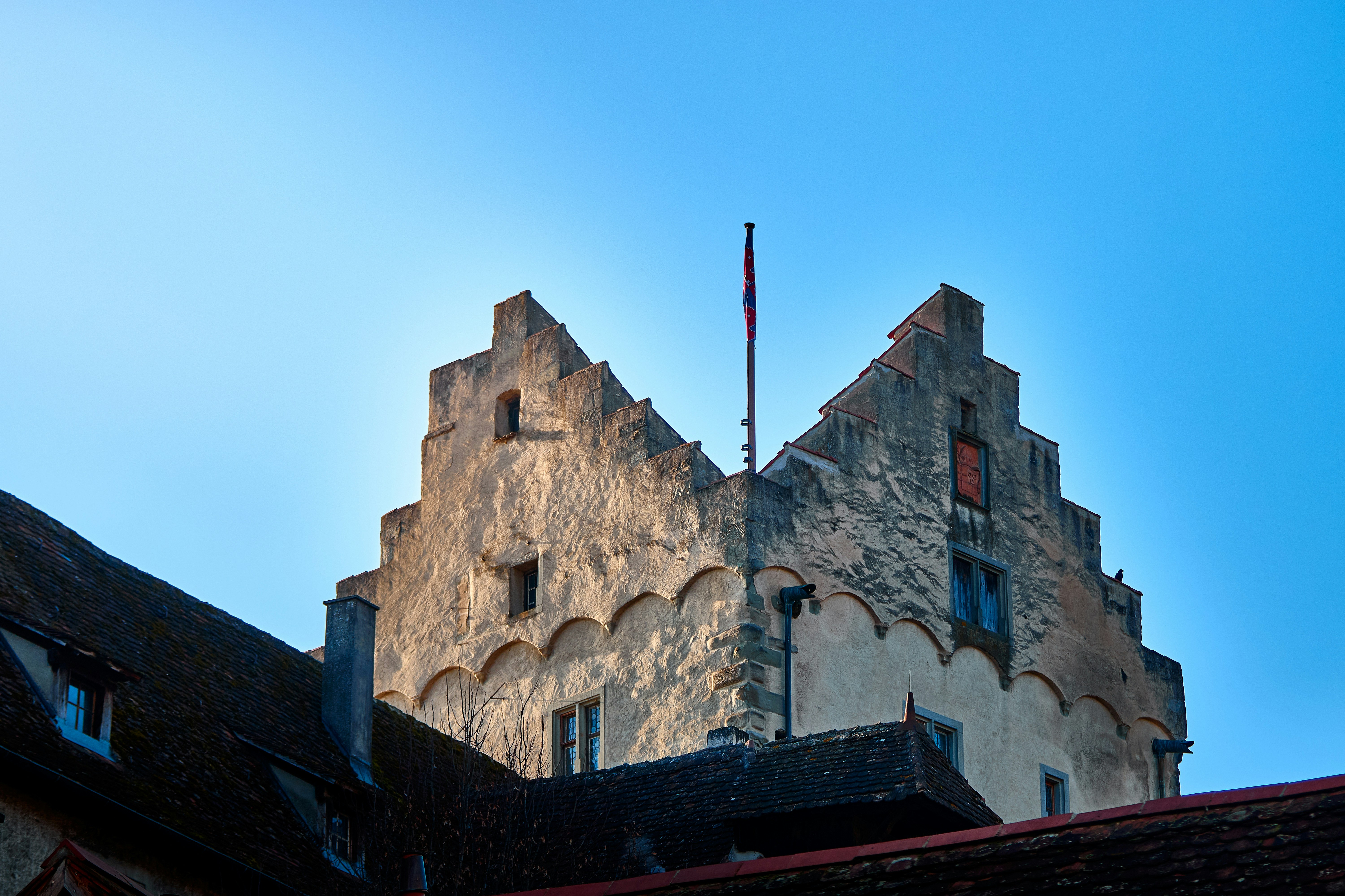 Historic building with stepped gable against blue sky