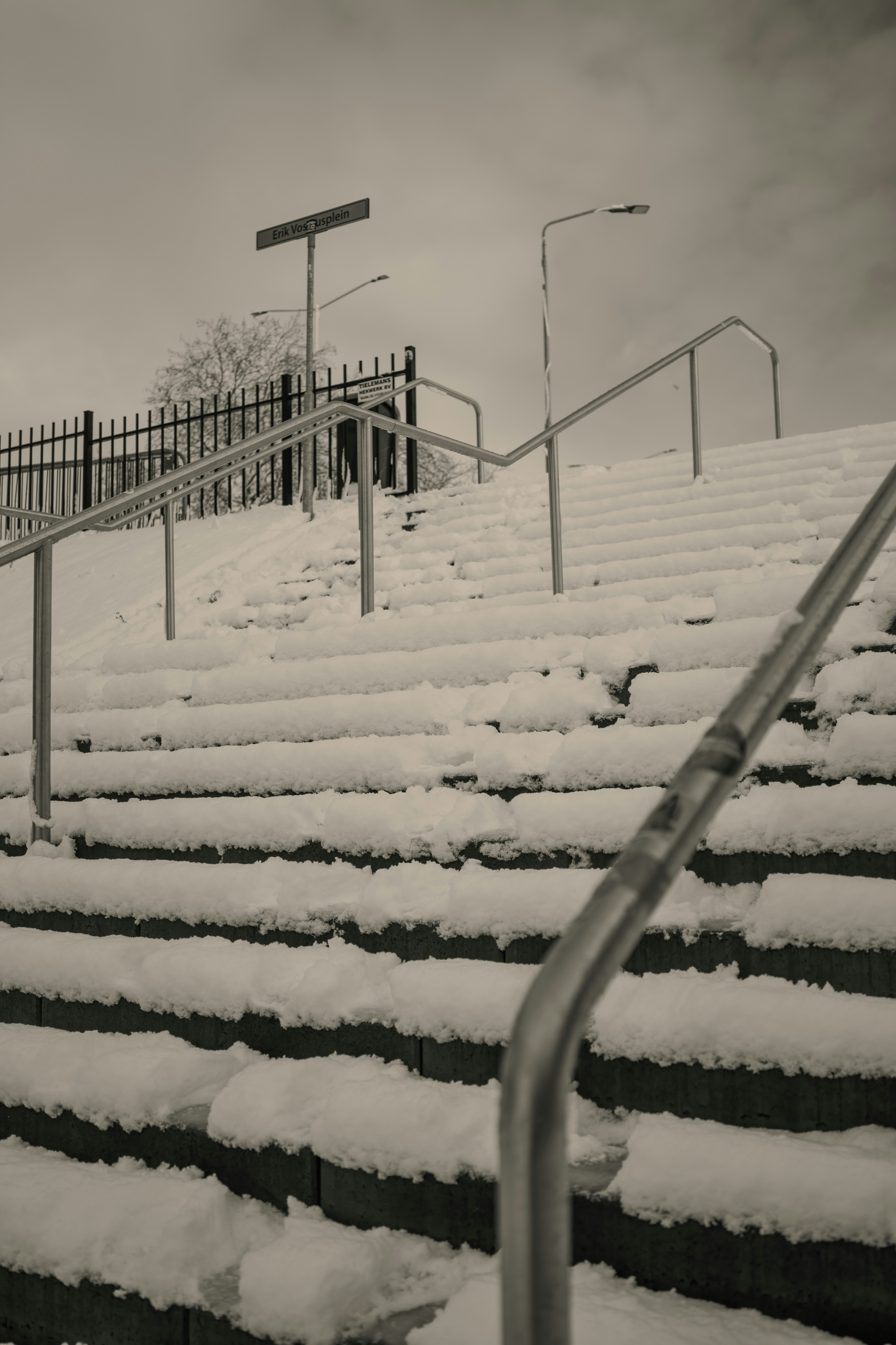 Snow covered outdoor stairs with metal railings