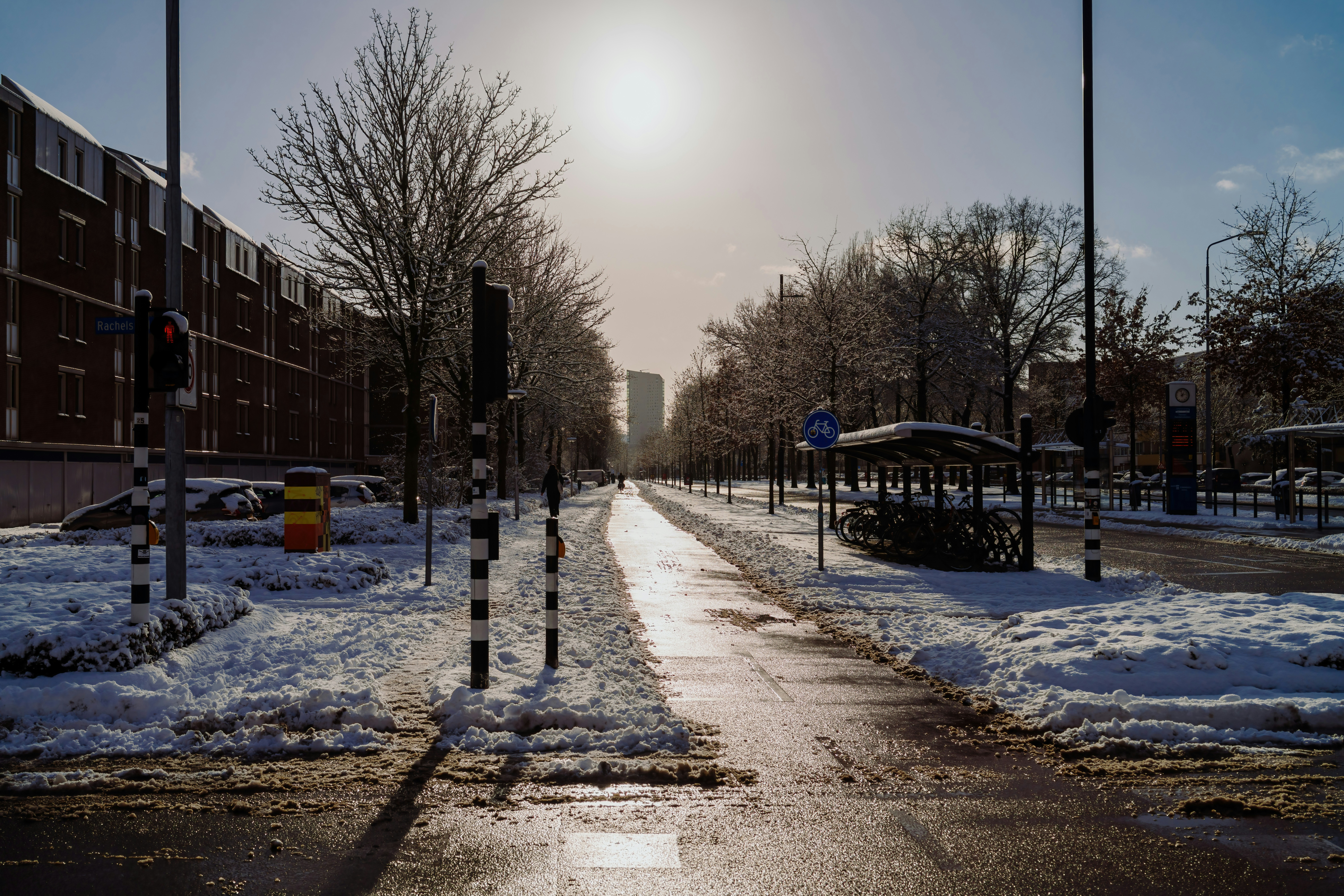A sunny winter day on a snow-covered street.