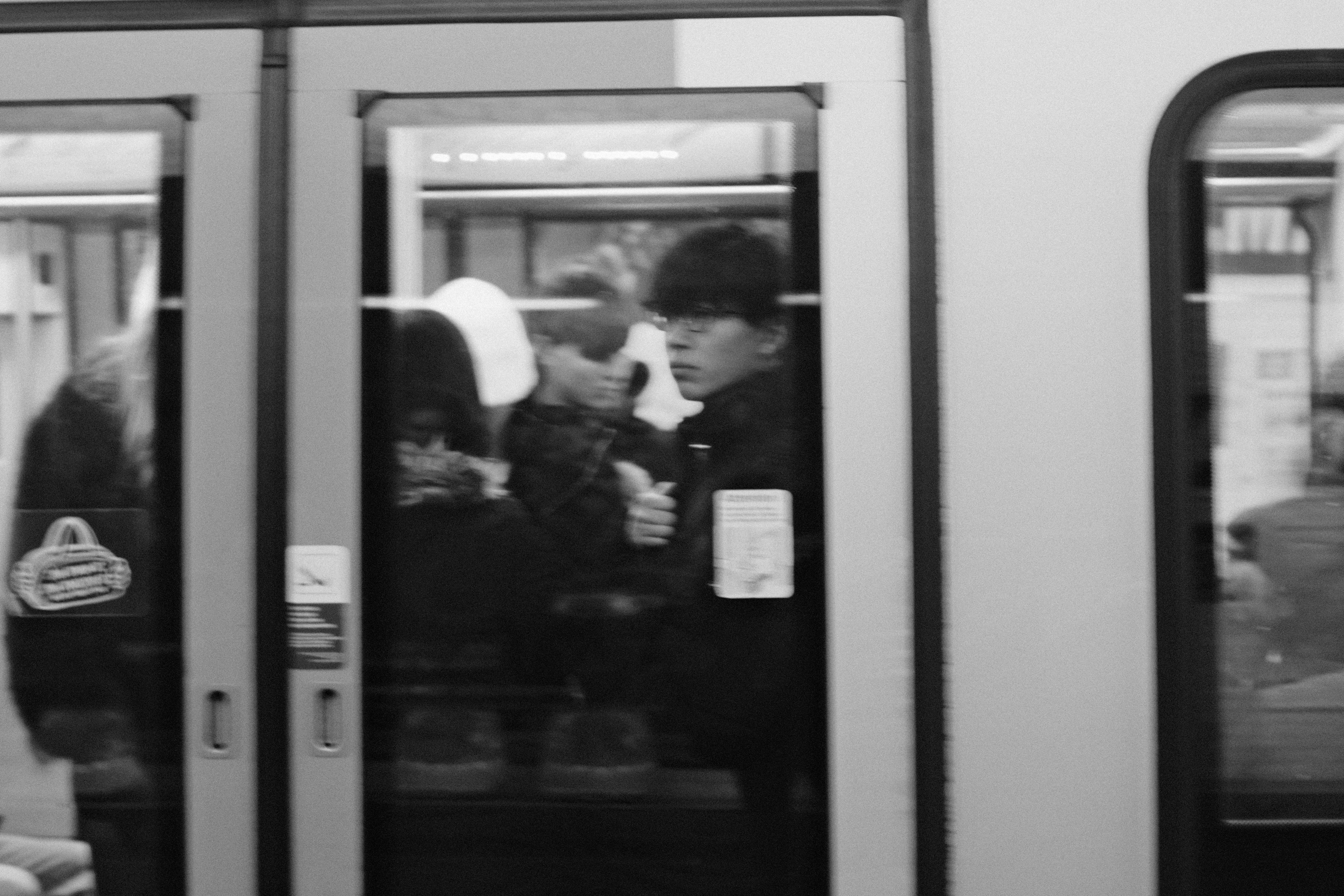 Young man looking out from a train door