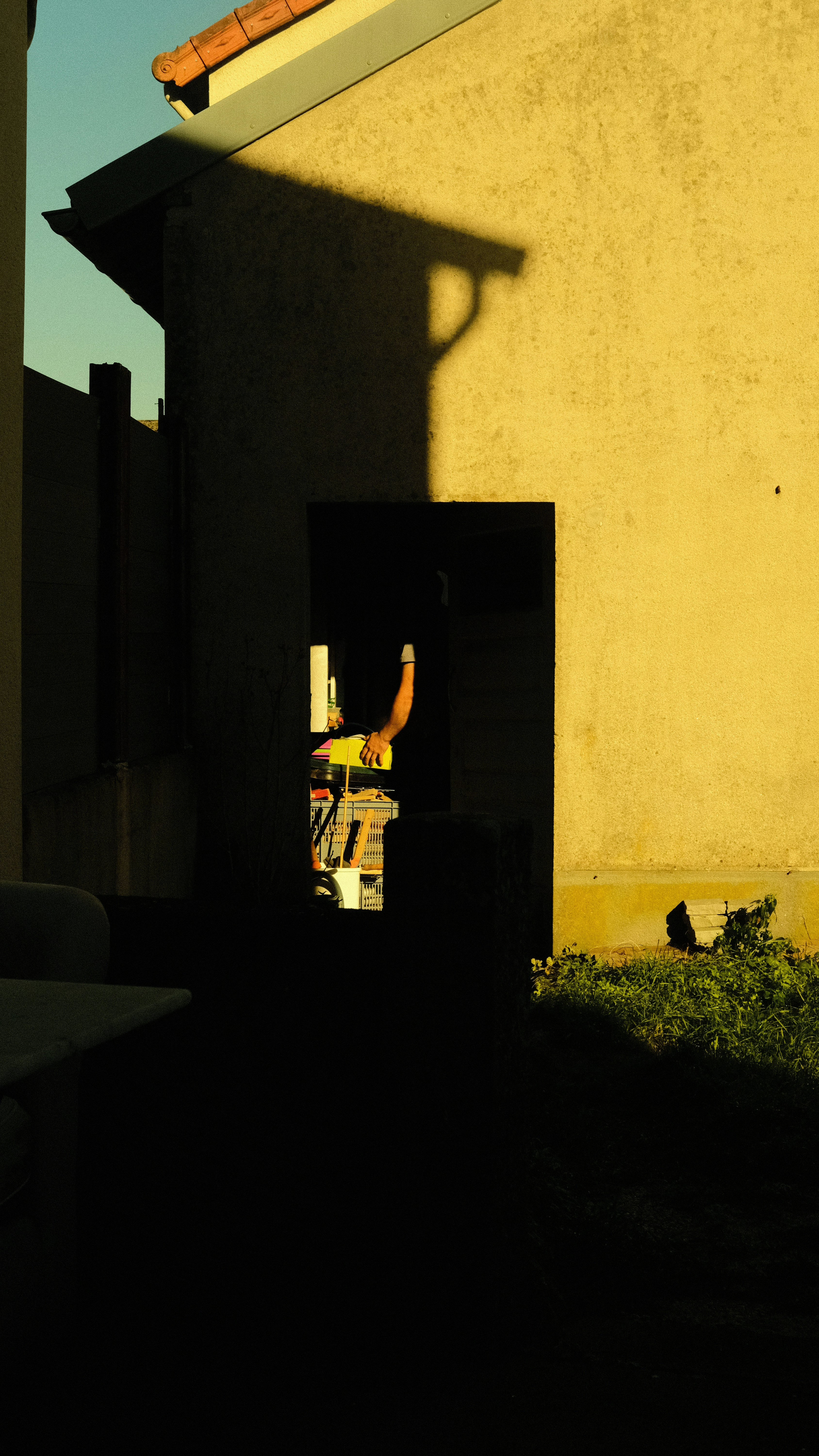 A person is silhouetted against a doorway.