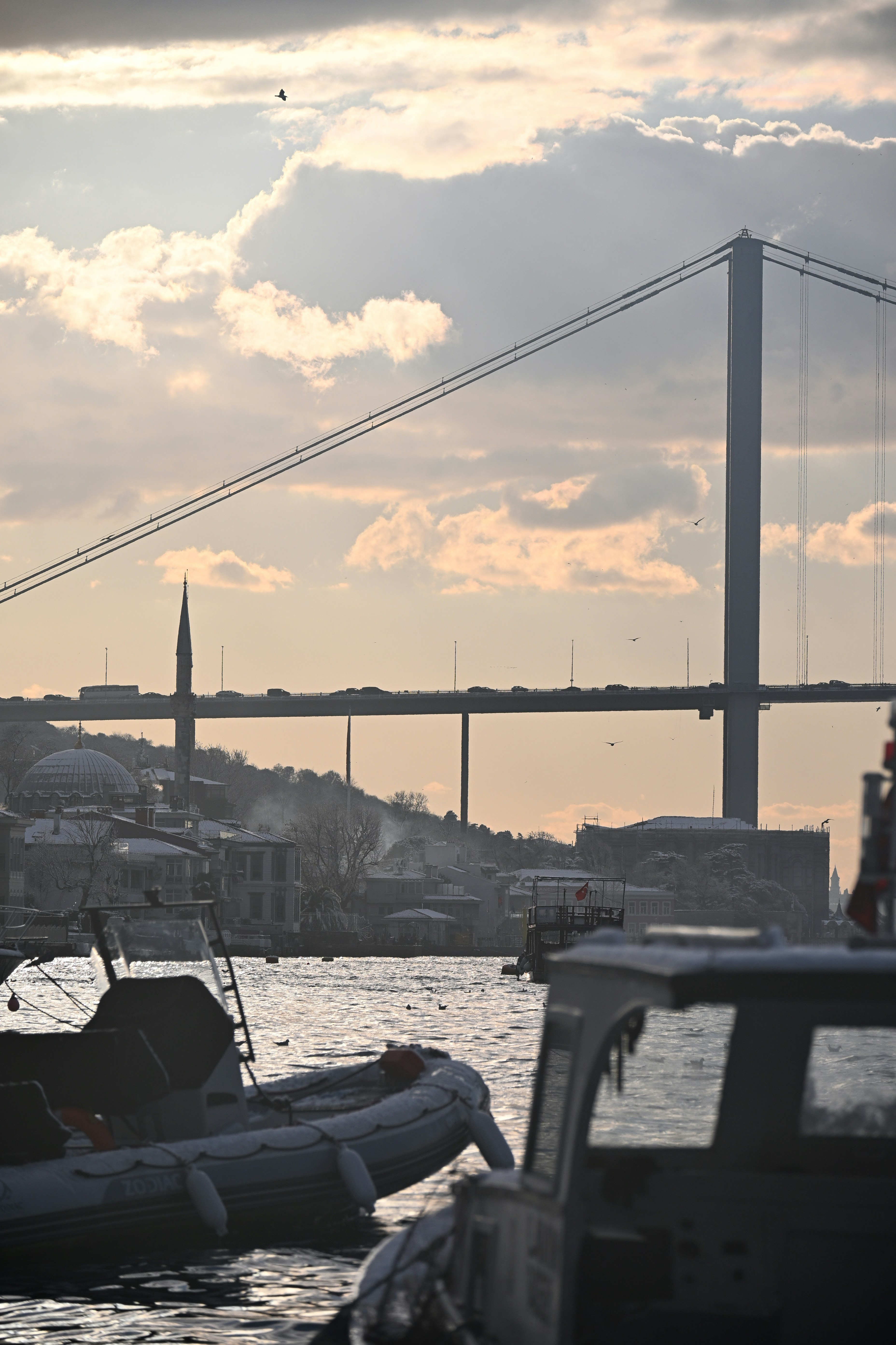 Bridge over water with boats in foreground