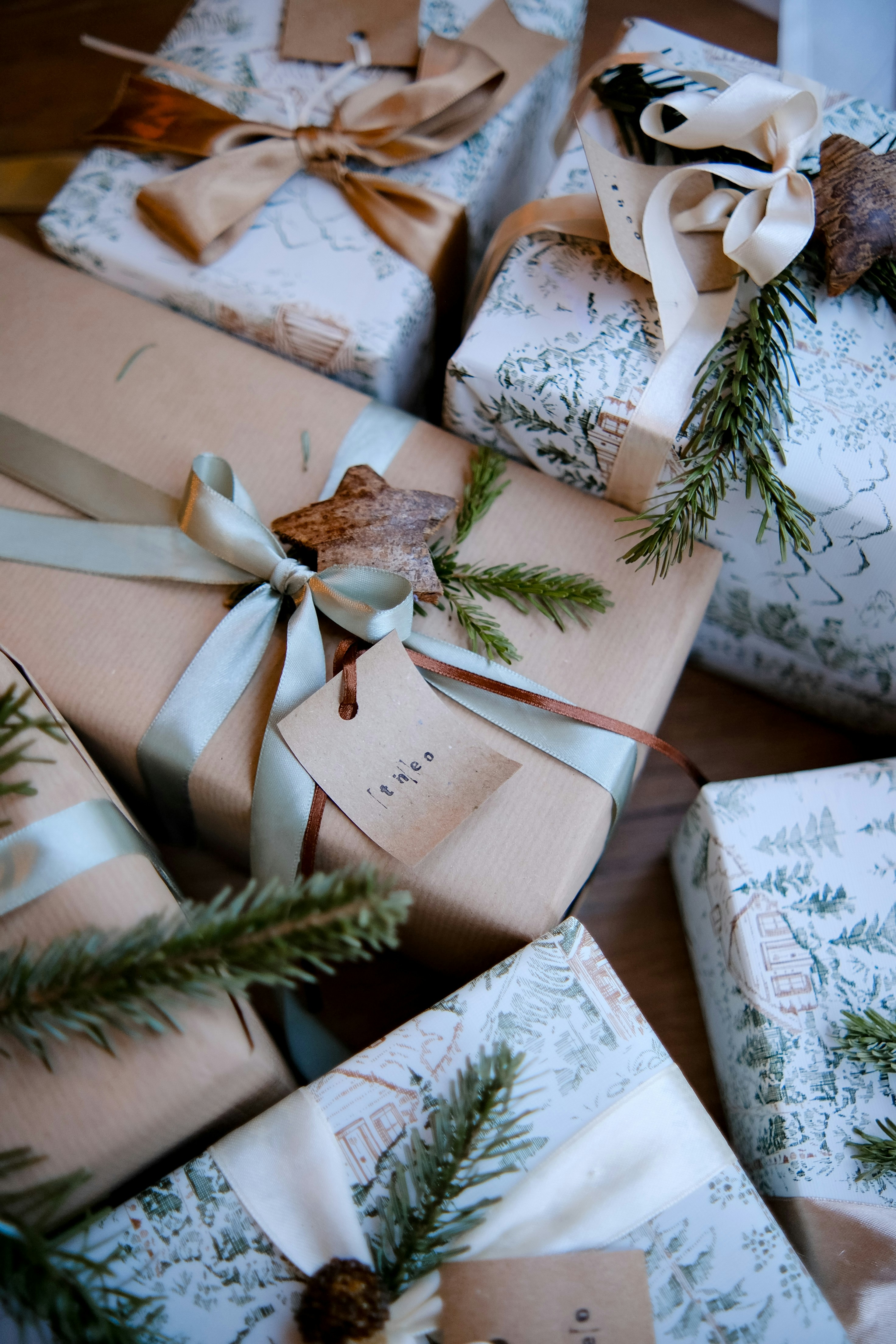 Wrapped gifts with pine sprigs and ribbons