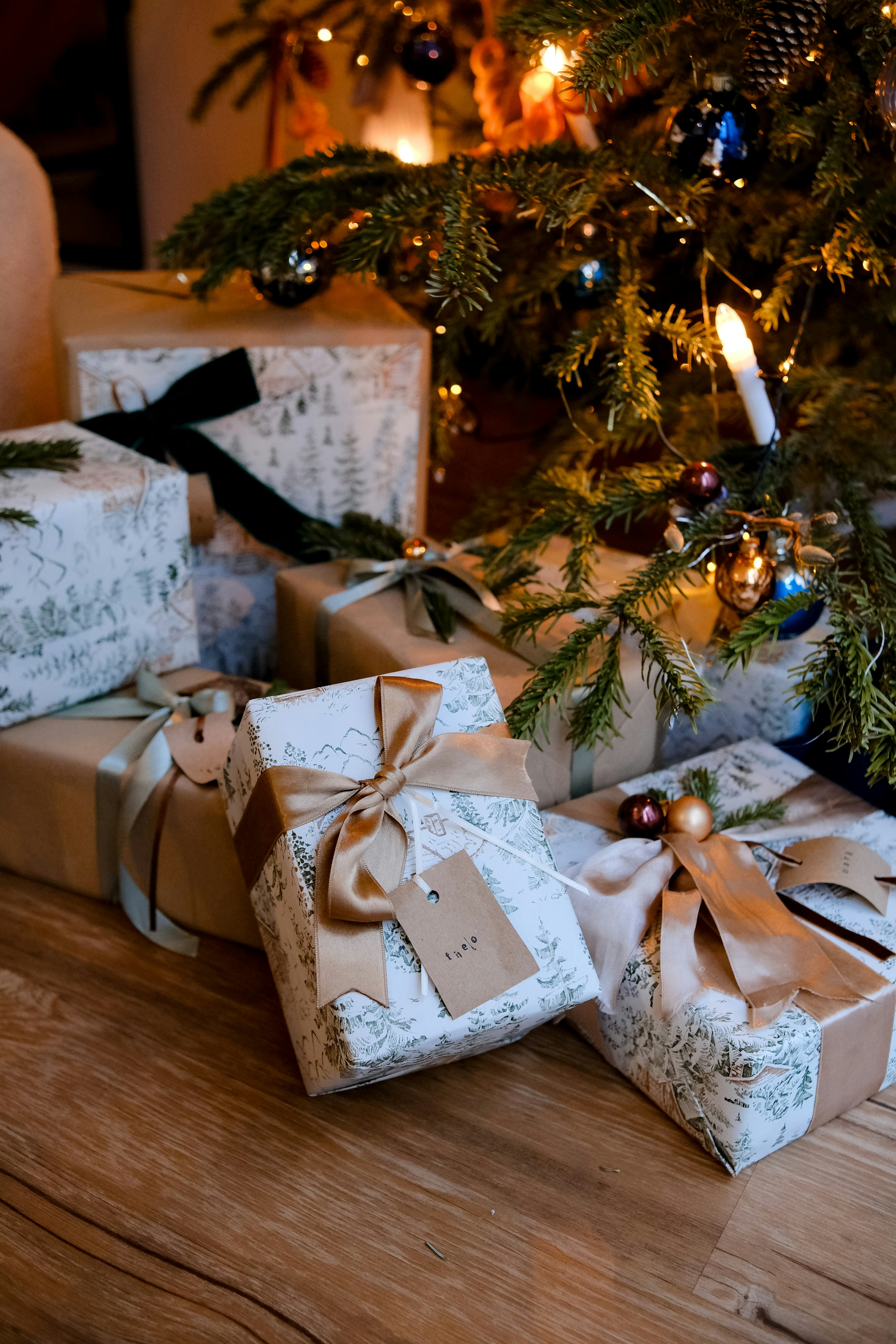 Christmas presents wrapped under a decorated tree