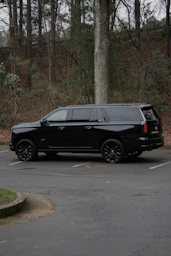 A black suv parked on a paved surface