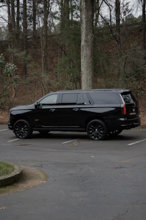 A black suv parked on a paved surface