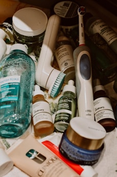 Assorted skincare products and an electric toothbrush.