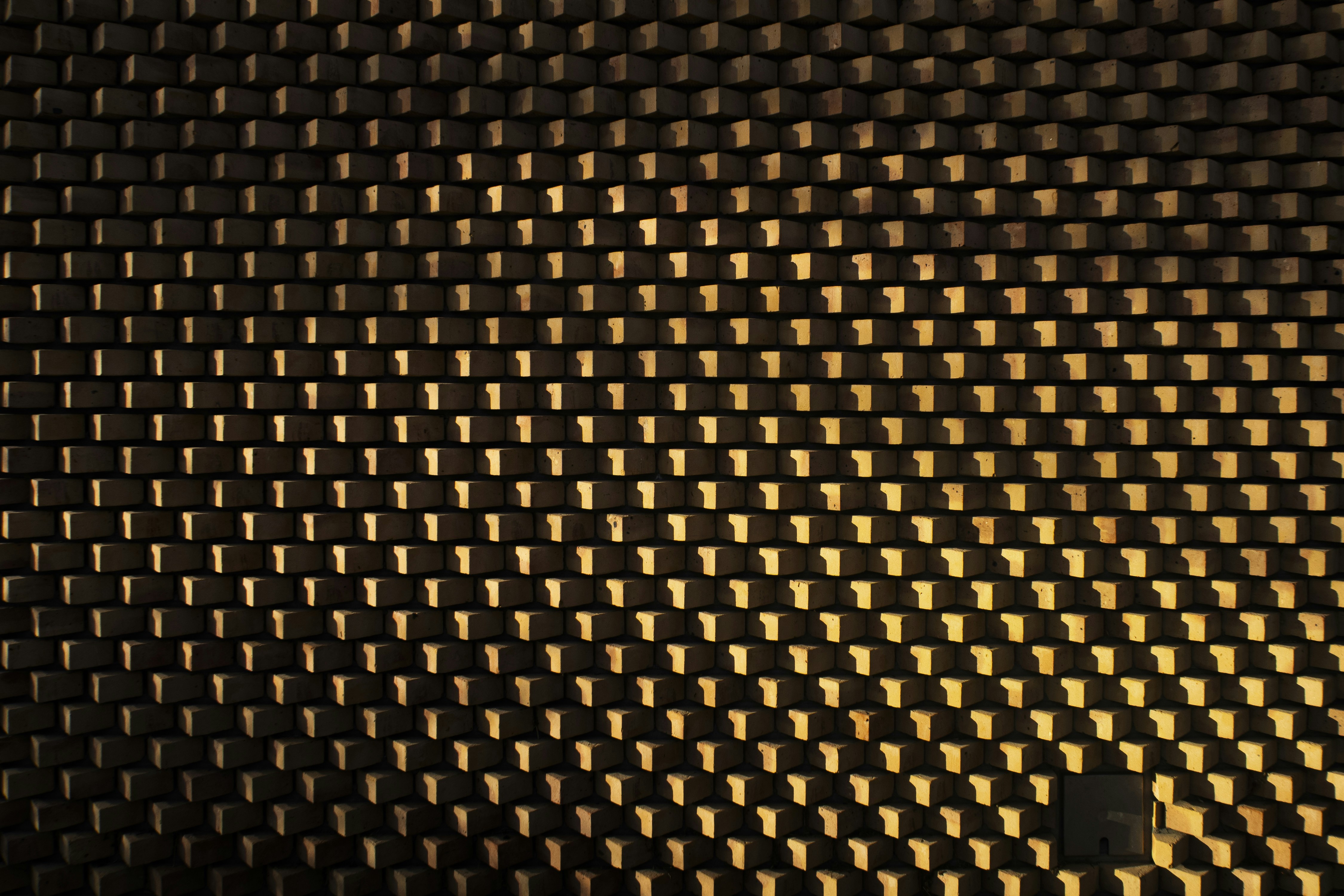 A textured dark surface with a golden sheen