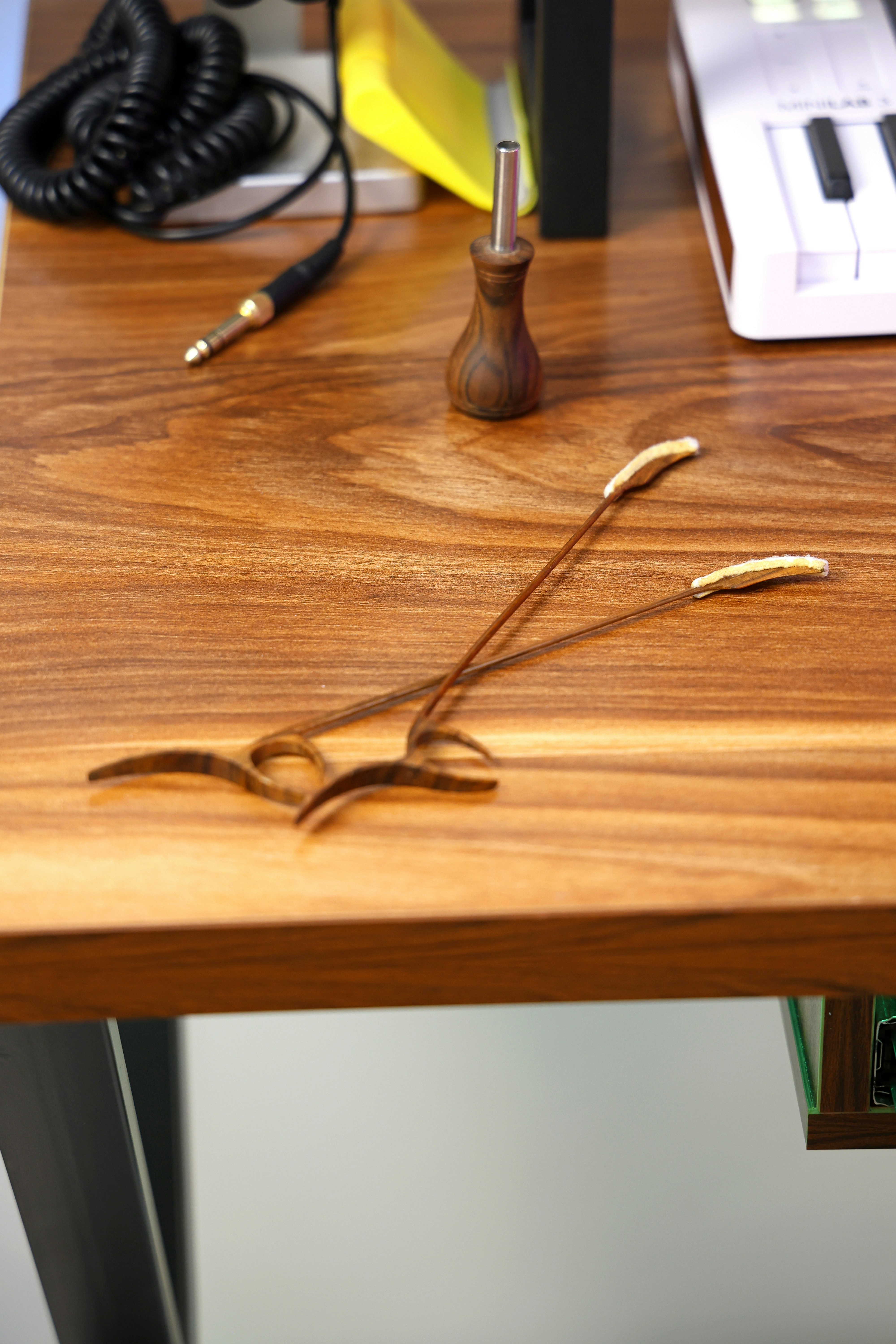 Two decorative wooden sticks on a desk
