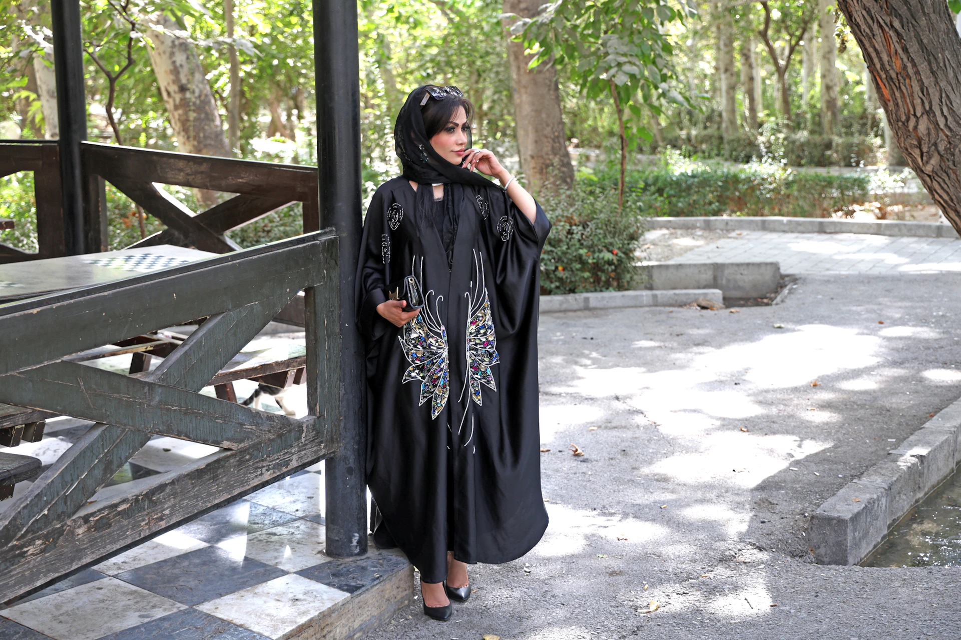 Woman in black abaya standing outdoors