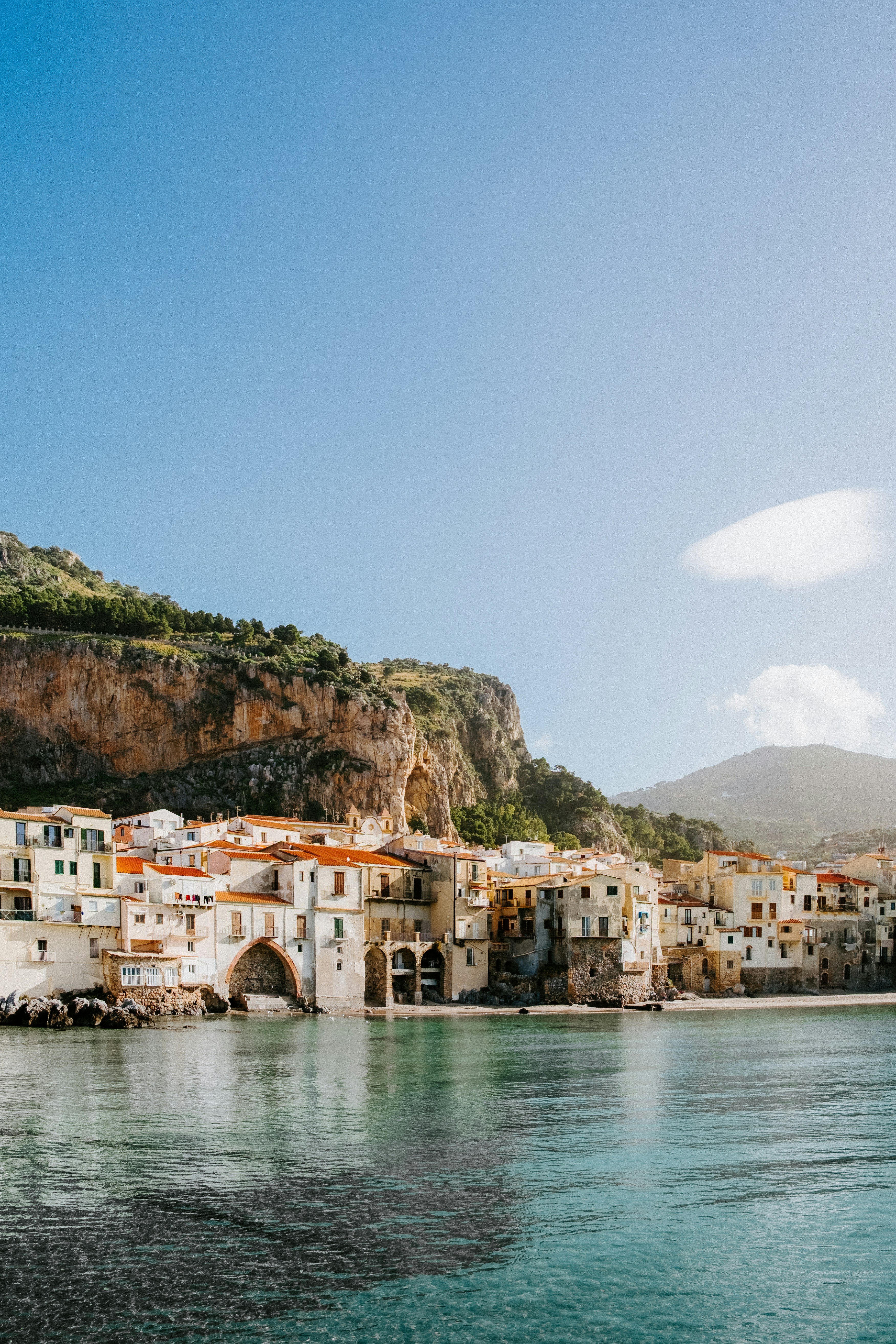 Coastal village with colorful buildings nestled against cliffs.