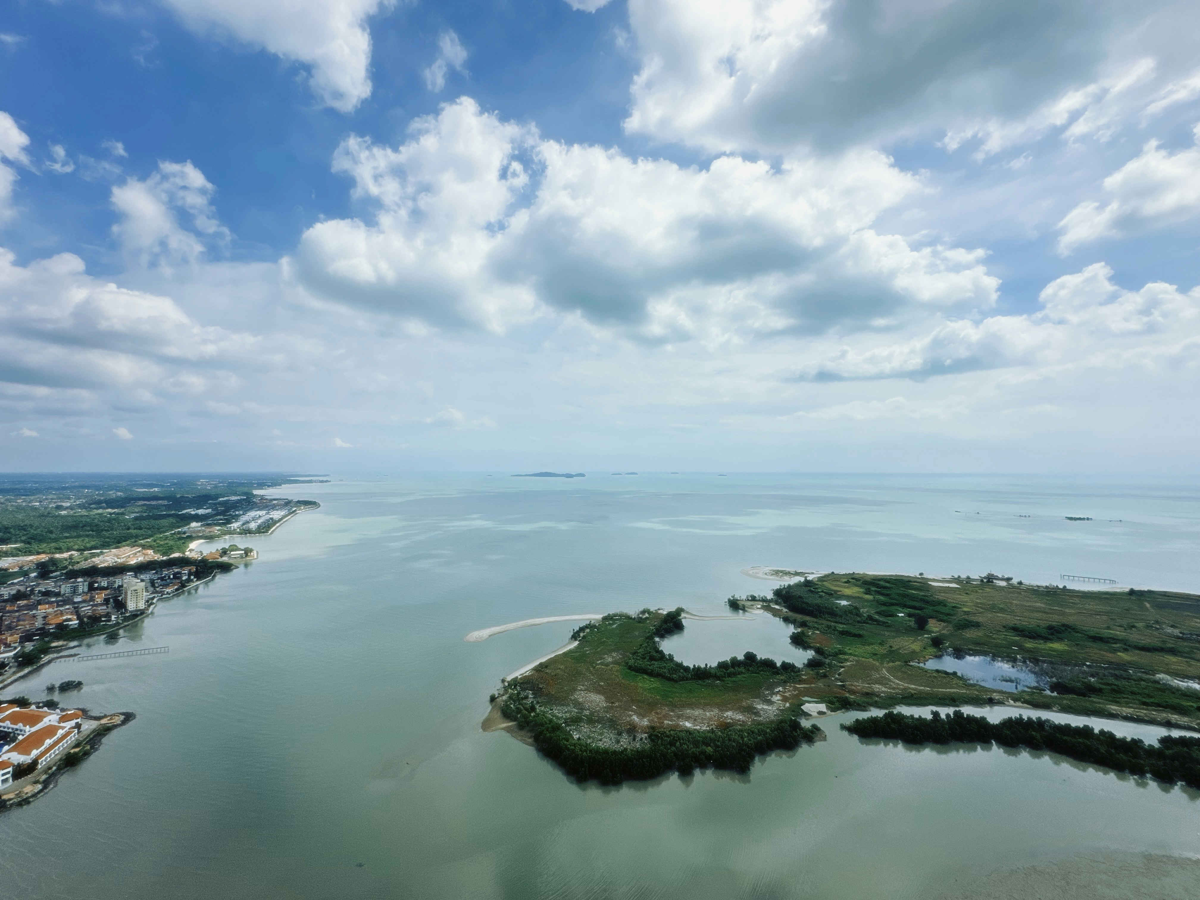 Coastal view with islands and calm water under clouds