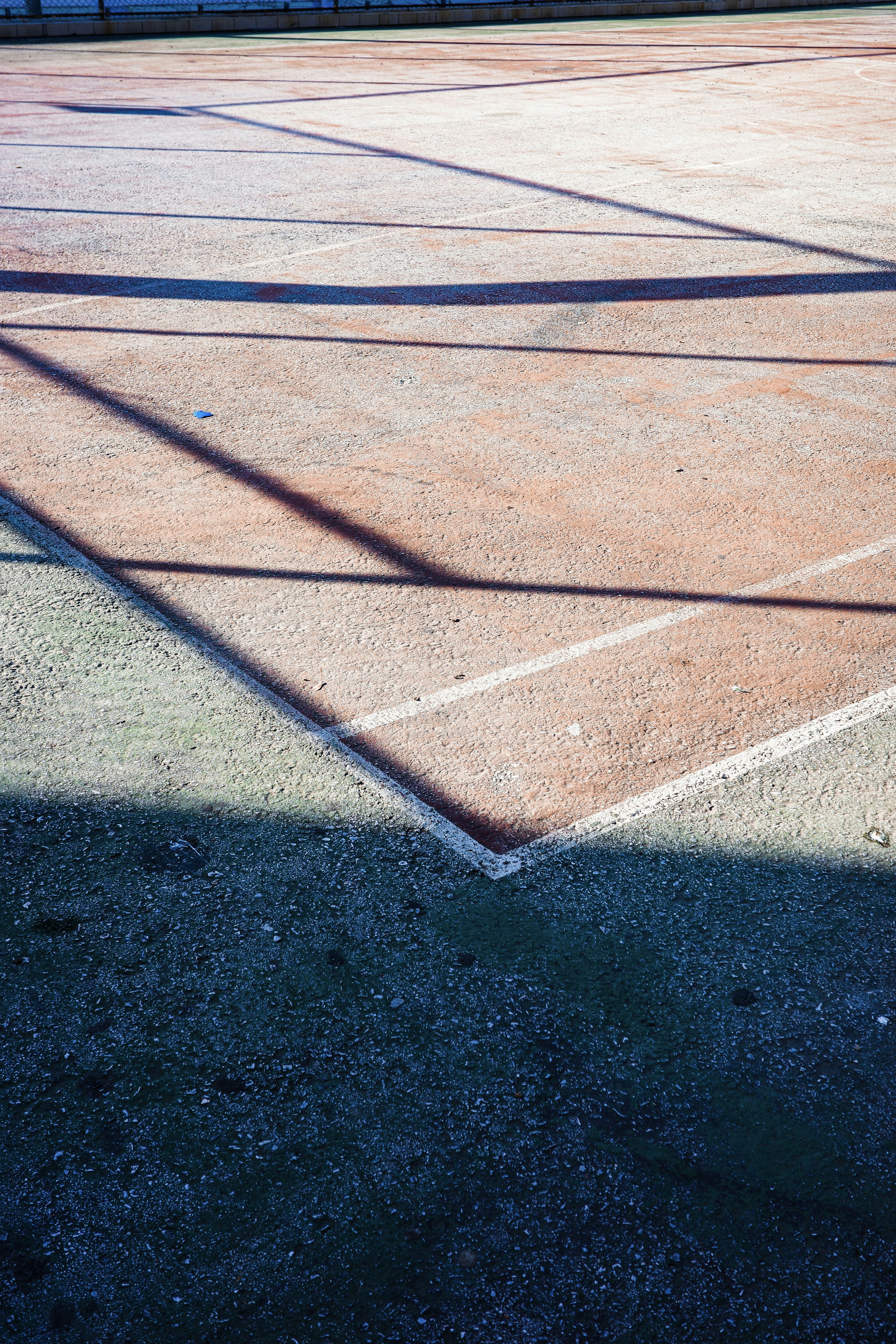 Shadows cast across a tennis court