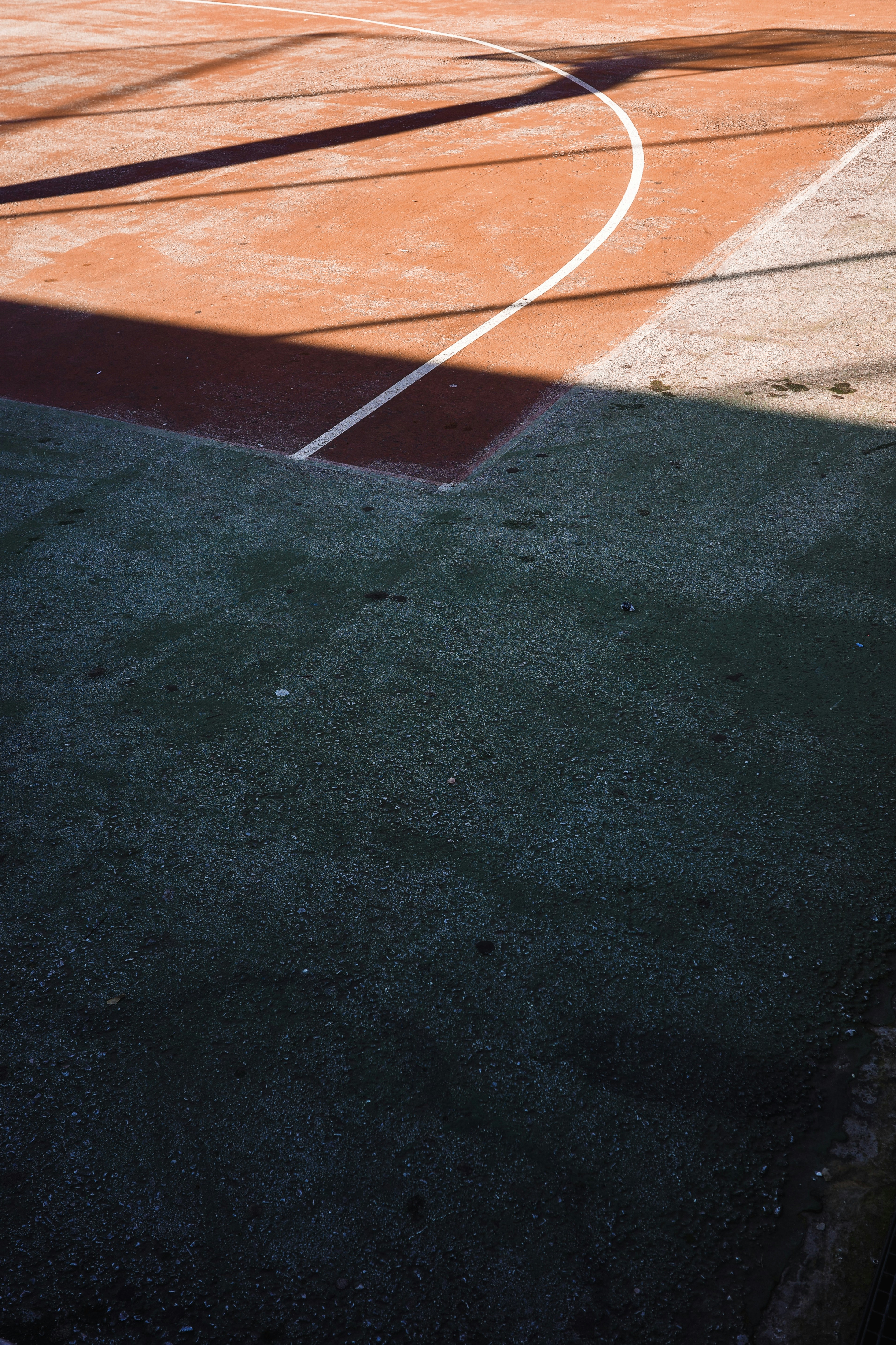 Shadows fall across a basketball court