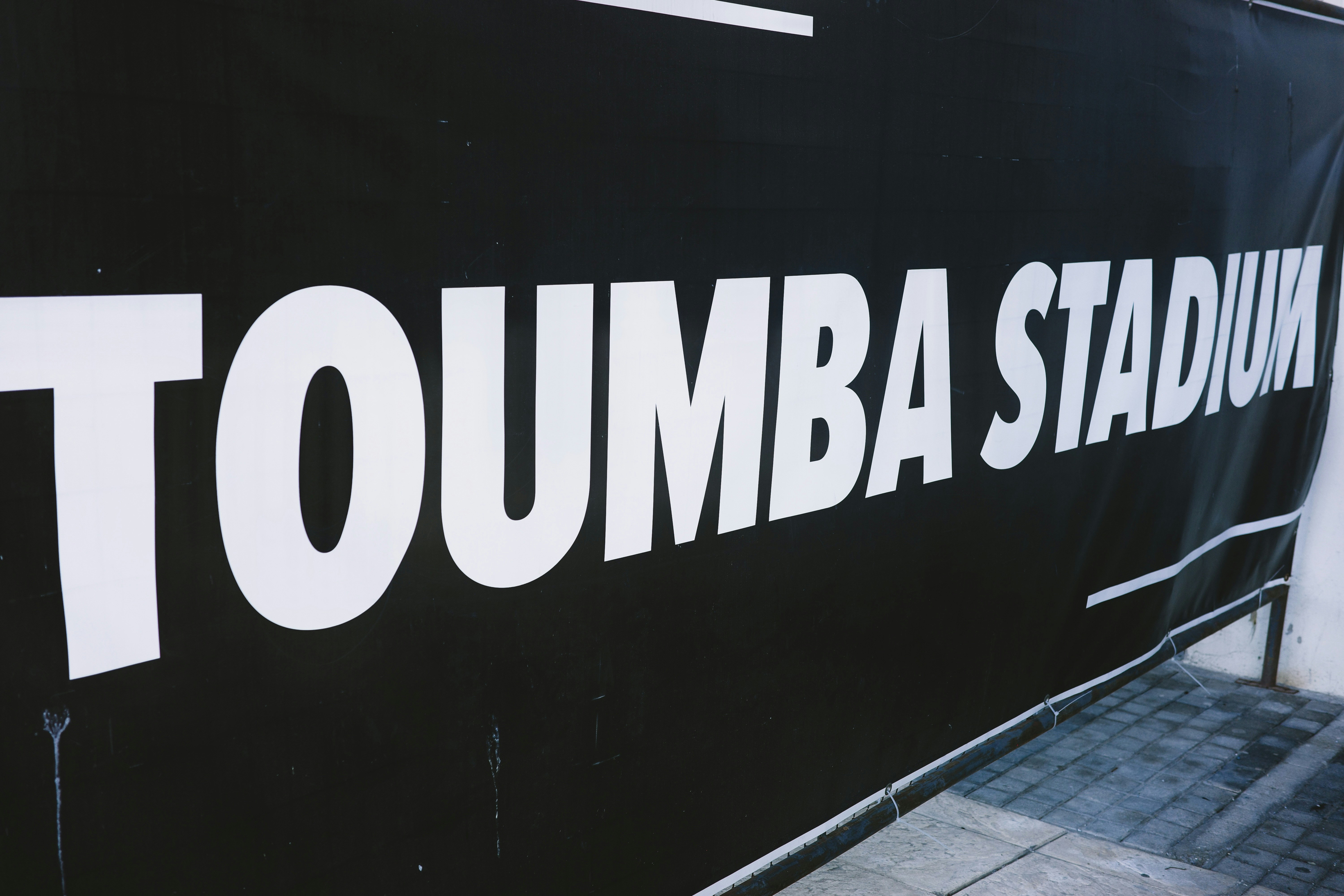 Toumba stadium sign on black background